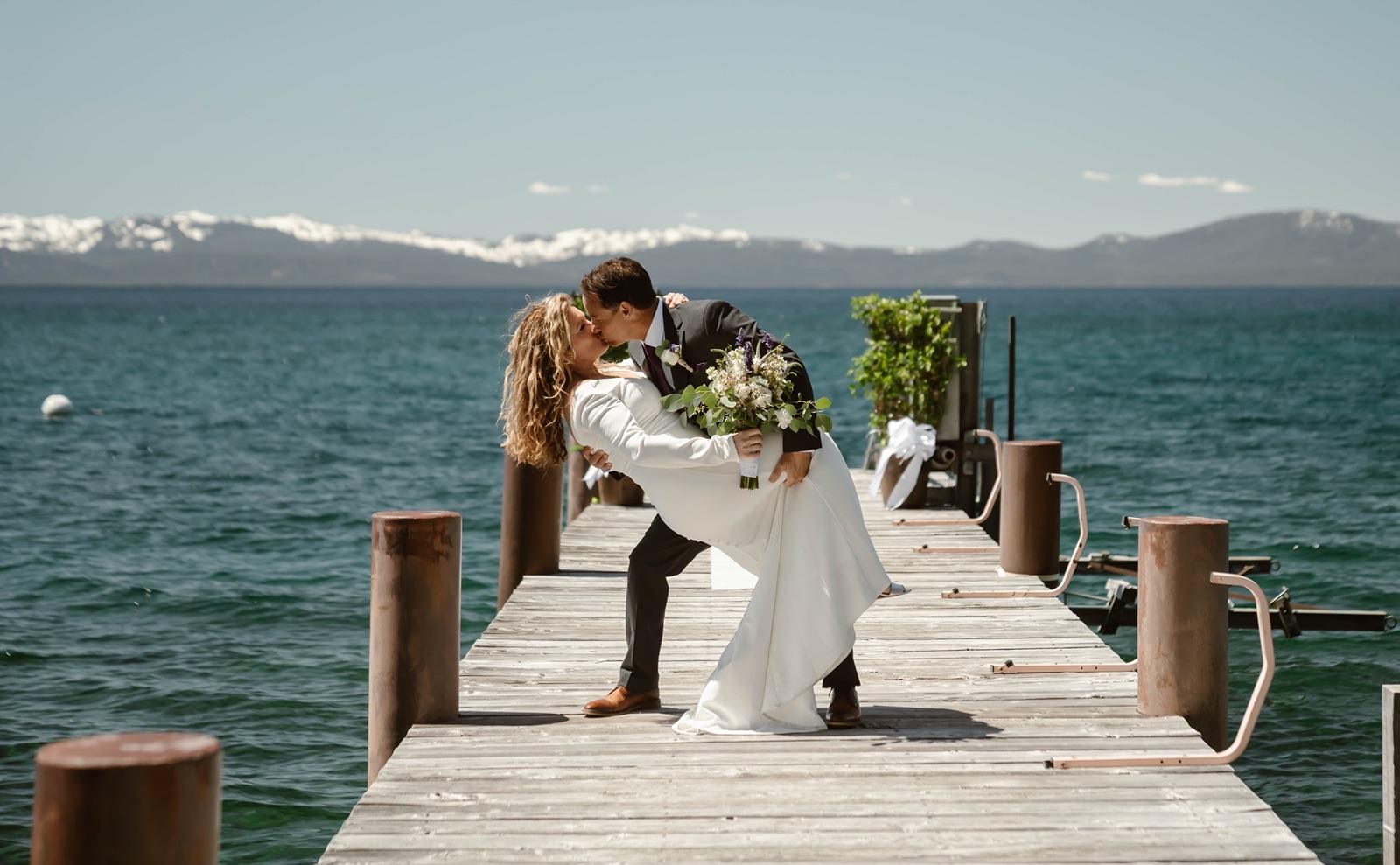 Bride and groom kiss with Lake Tahoe as the backdrop