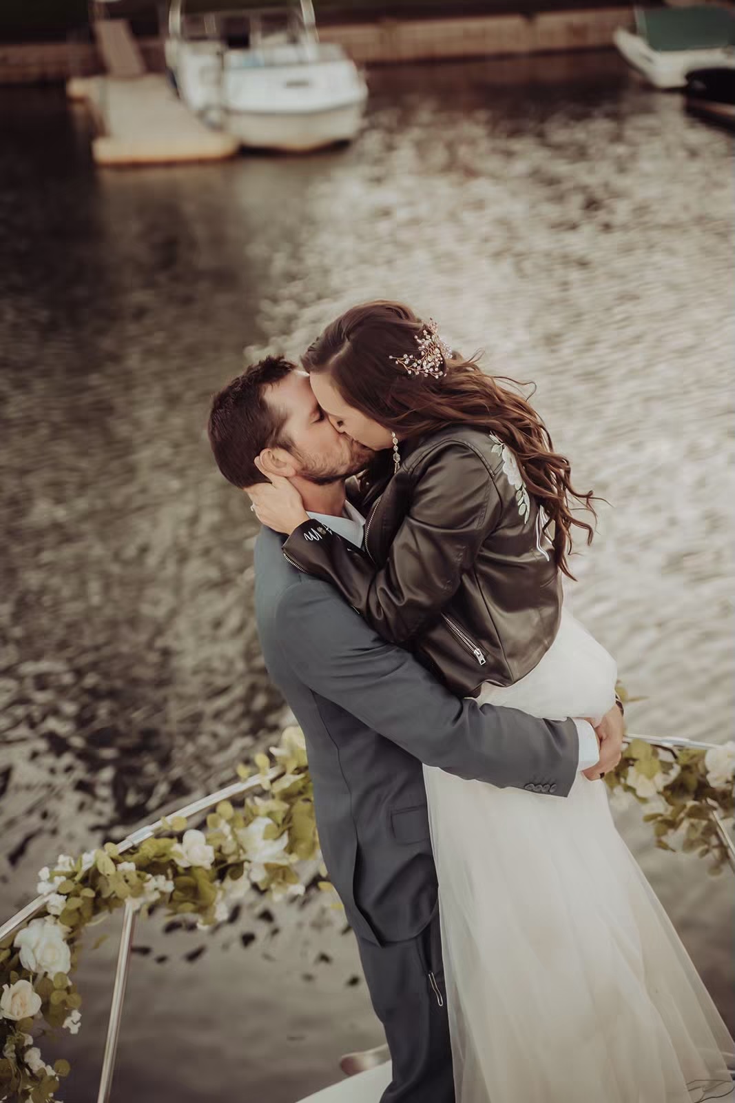 Bride and groom kiss on a boat on Lake Tahoe