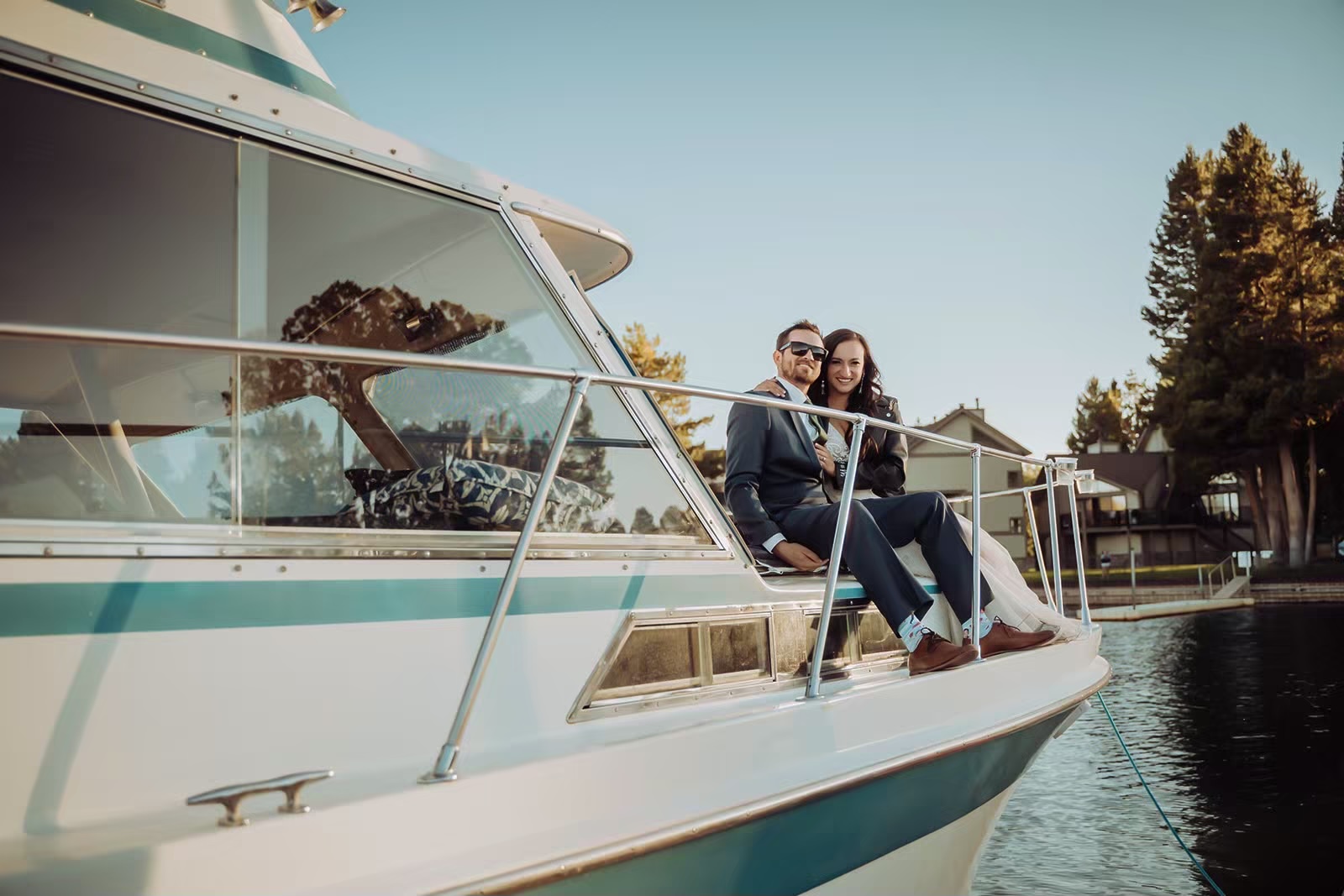 Bride and groom sit on boat together