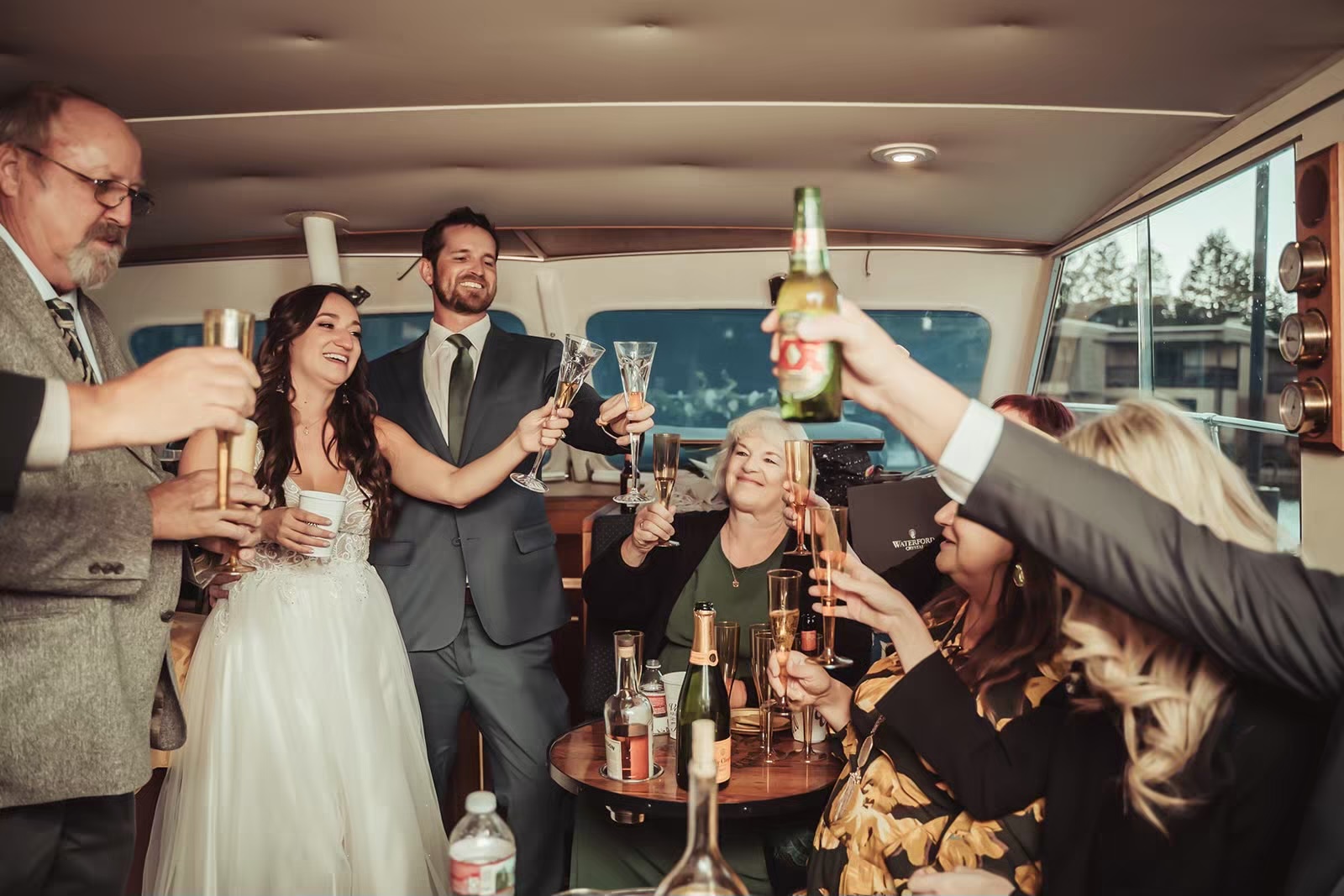 Bride and groom cheers with guests during Lake Tahoe boat wedding reception