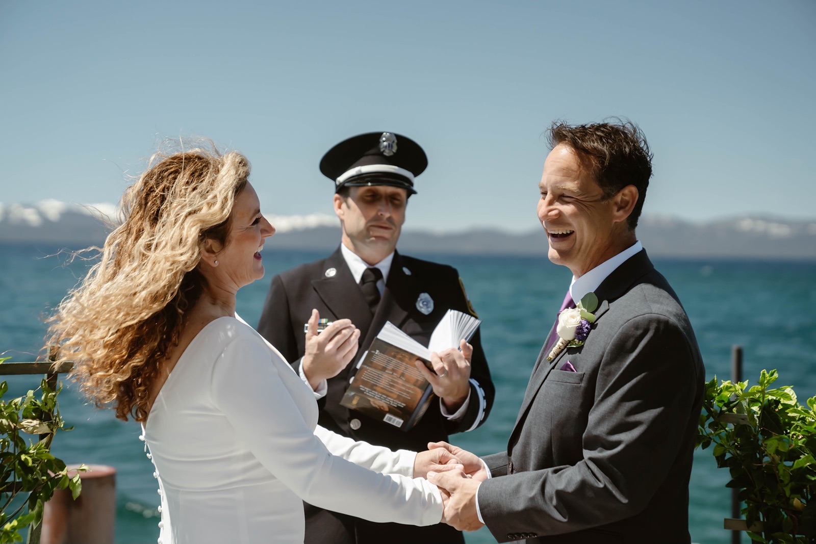 Bride and groom say their vows at their Lake Tahoe dock wedding