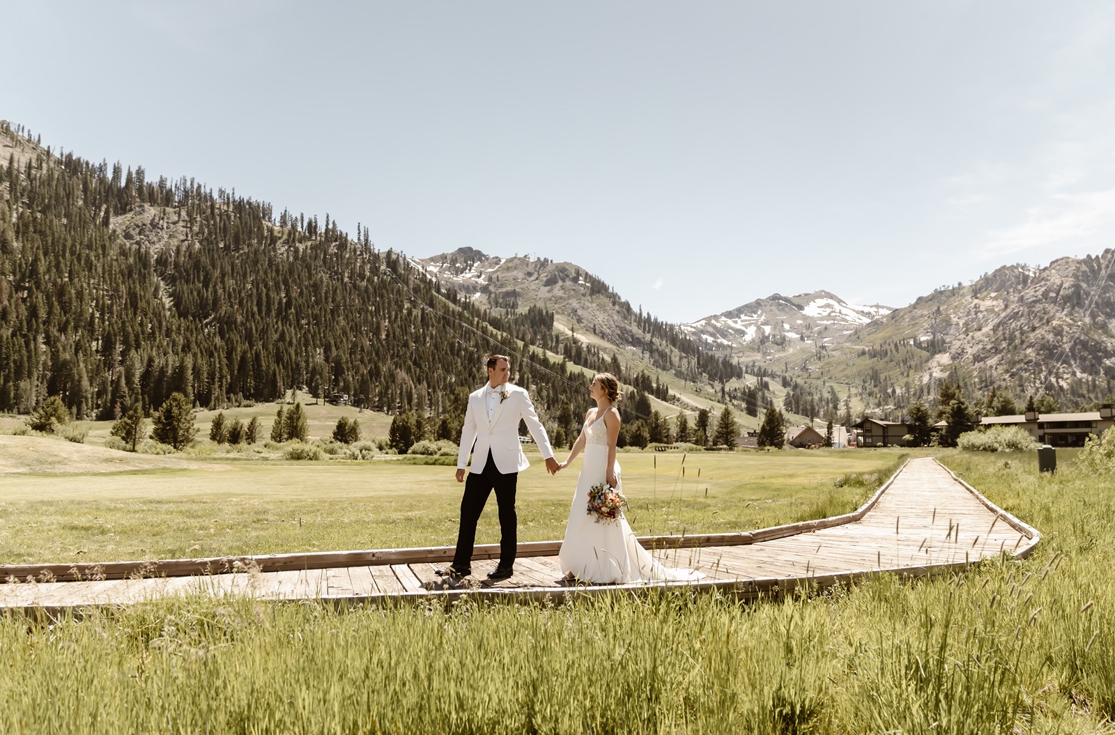 Bride and groom walk around the resort in Palisades Tahoe