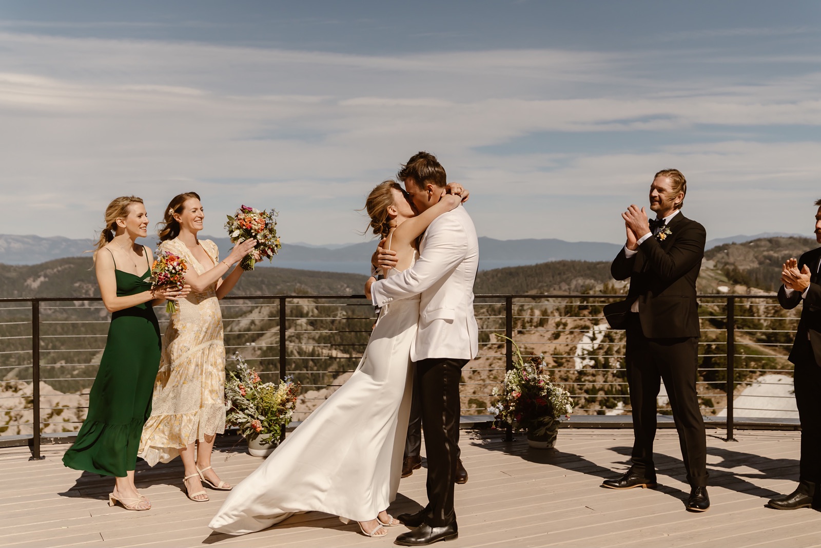 Couple kisses during their outdoor Palisades wedding ceremony