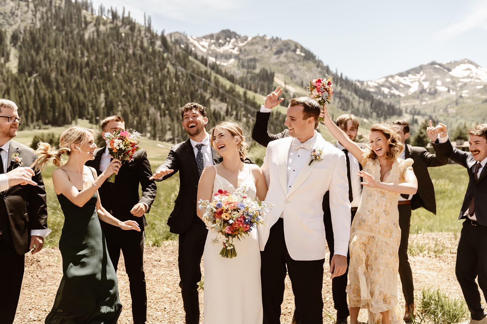 Bride and groom laugh with their wedding party at Palisades Tahoe