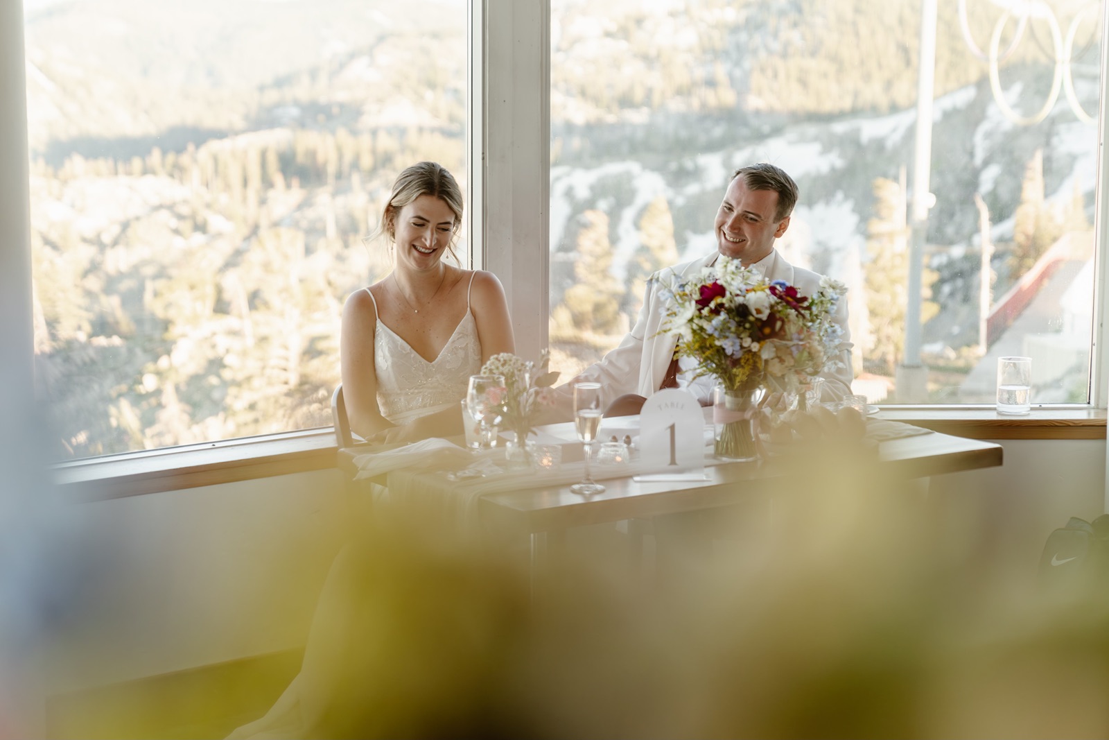 Bride and groom laugh during their Palisades wedding toasts