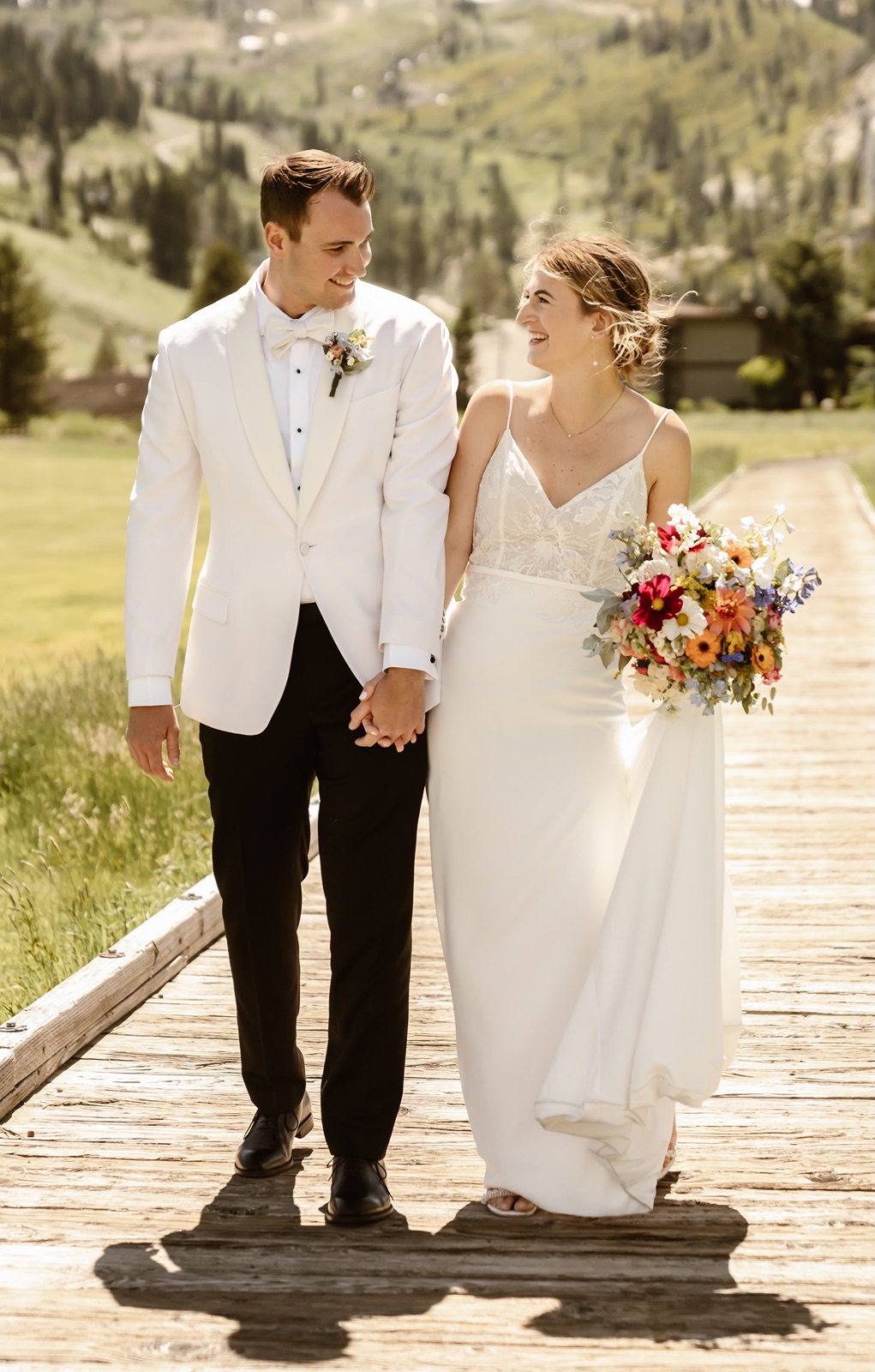 Bride and groom walking while holding hands