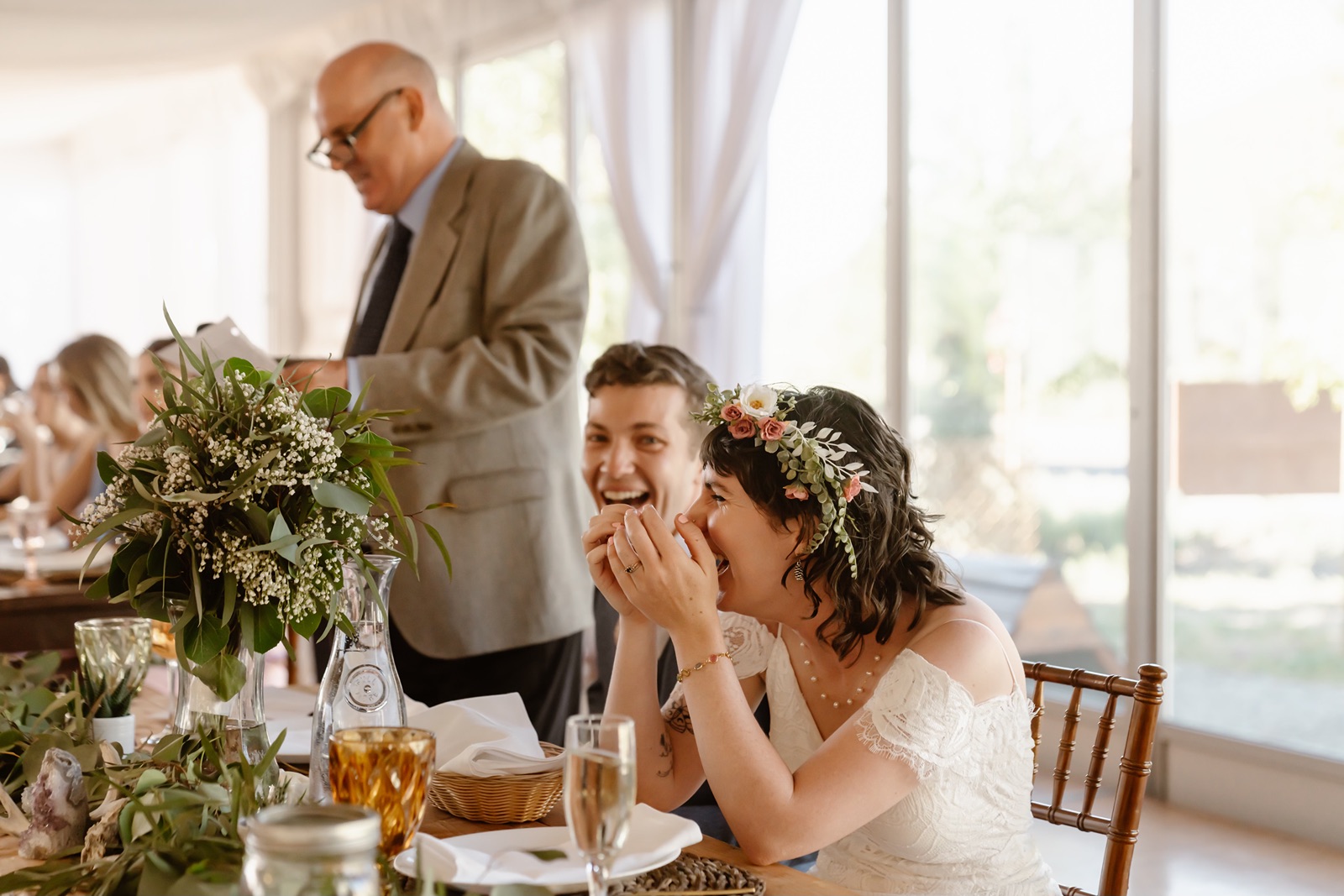 Bride and groom laugh during wedding toasts at the Convict Lake Resort wedding reception