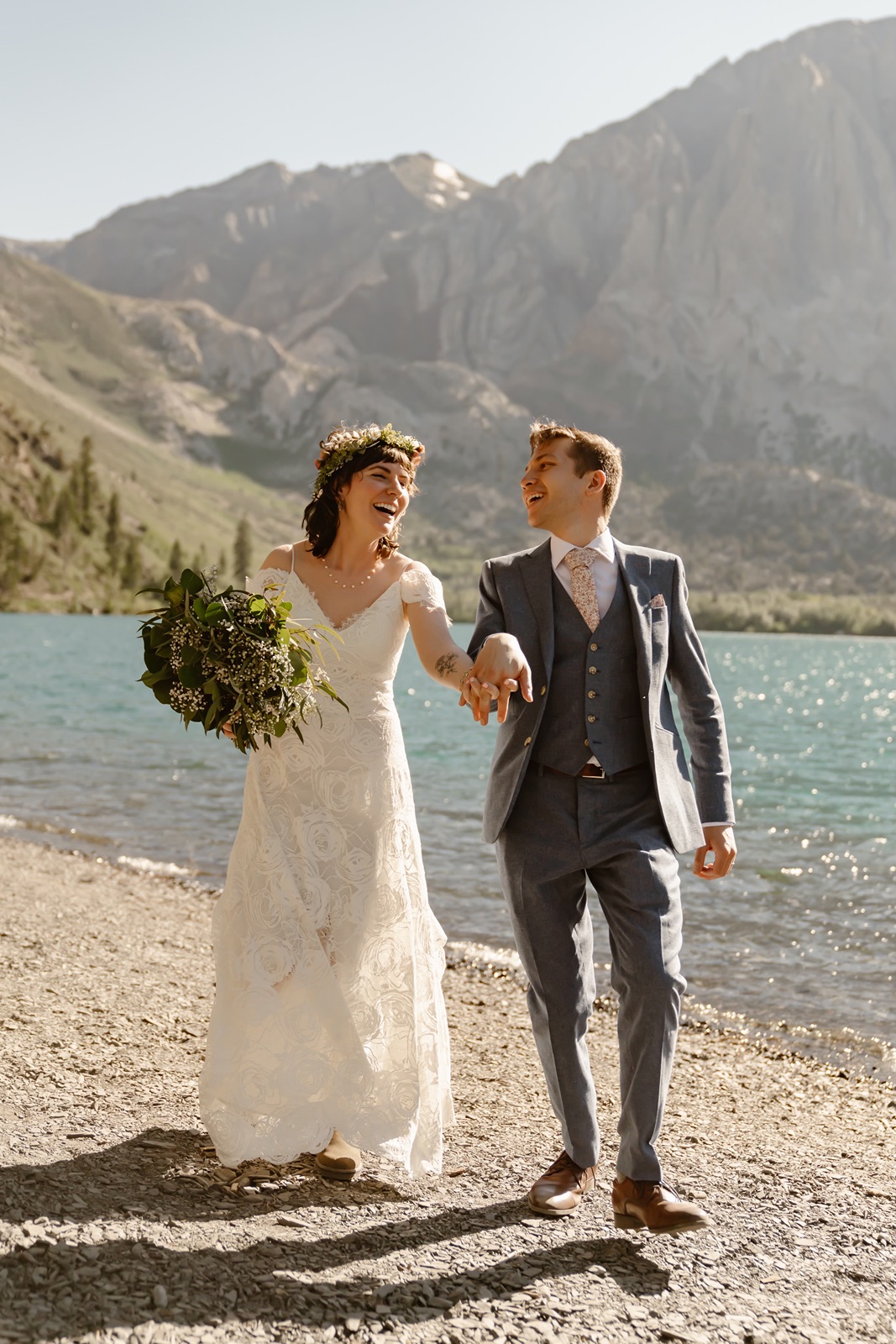 Bride and groom hold hands at Convict Lake