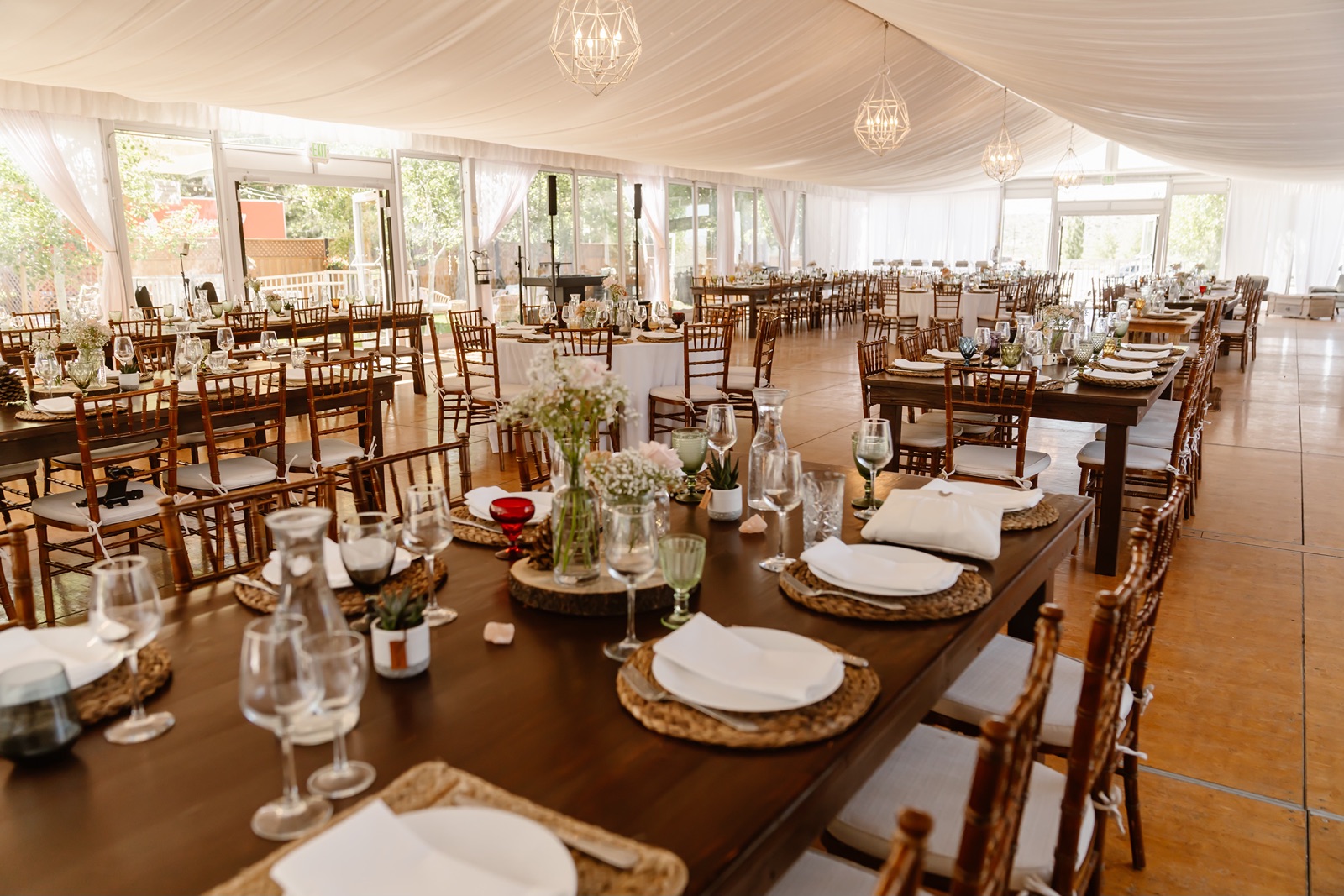 Guests found their seats at long farmhouse tables at the Convict Lake Resort wedding reception