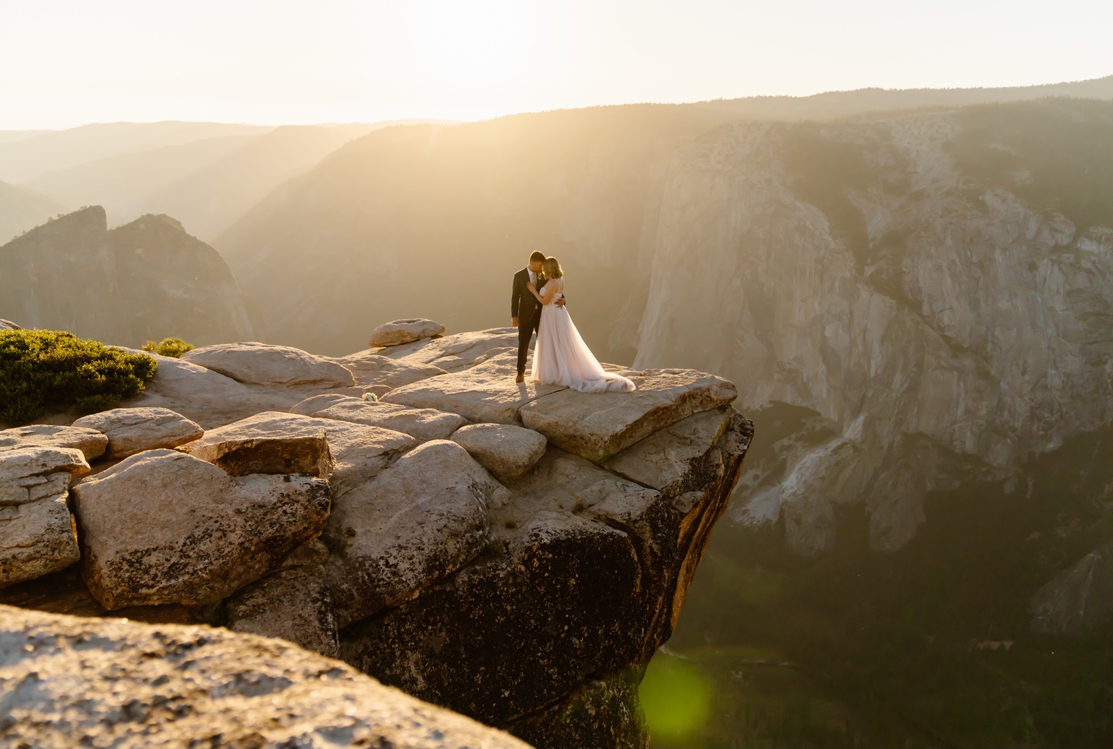 Couple at the edge of a cliff during Yosemite elopement photos