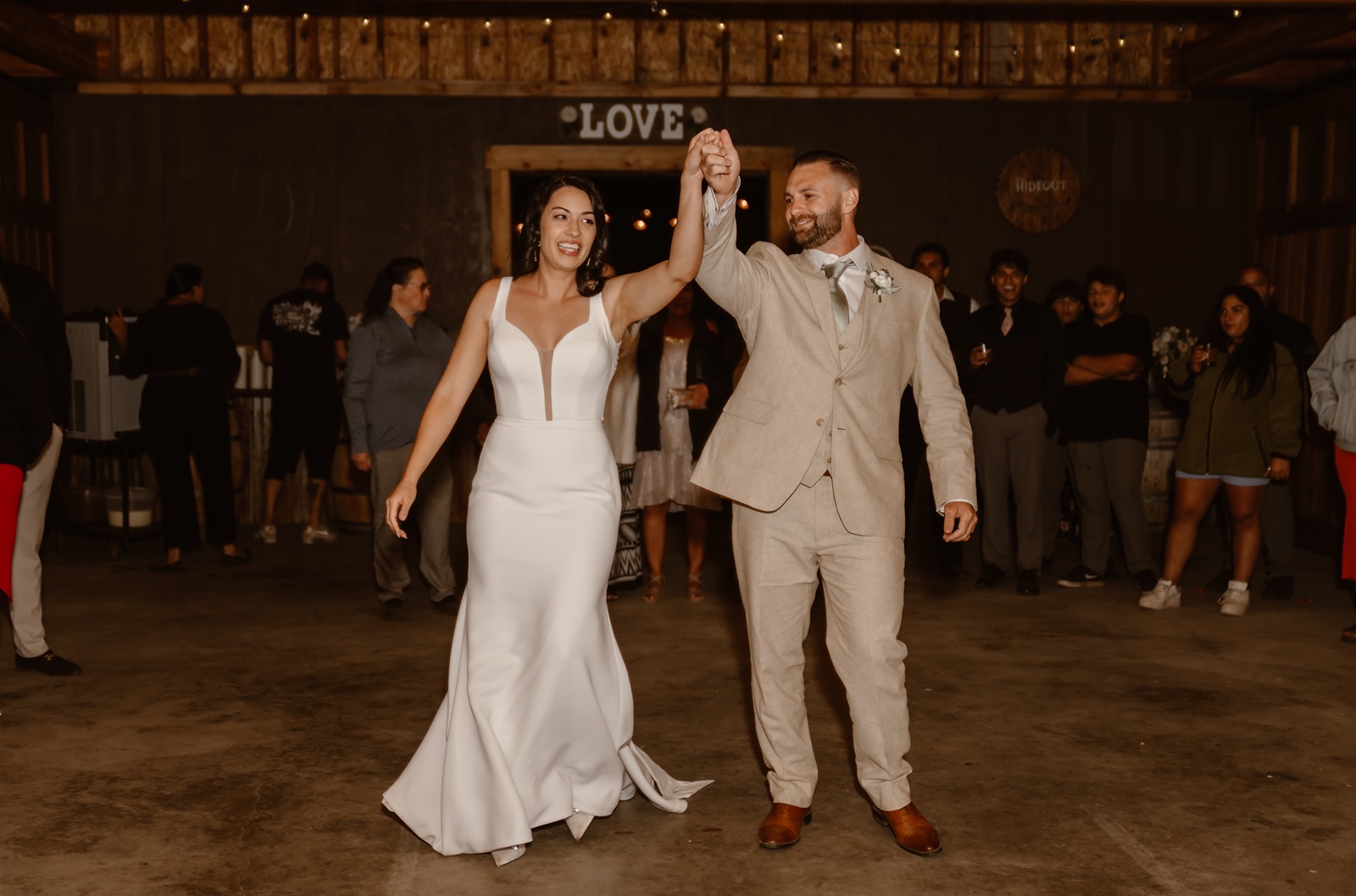 Bride and groom hold hands as they enter Hideout at Kirkwood wedding reception