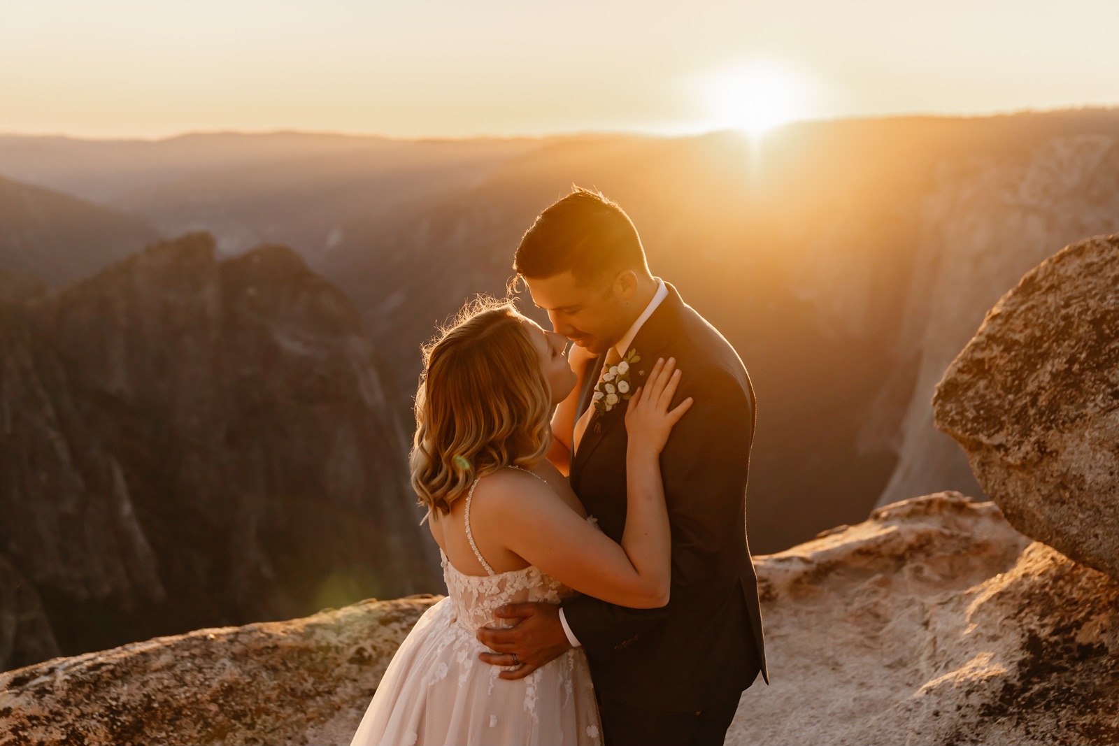 Bride and groom embrace at sunset in Yosemite