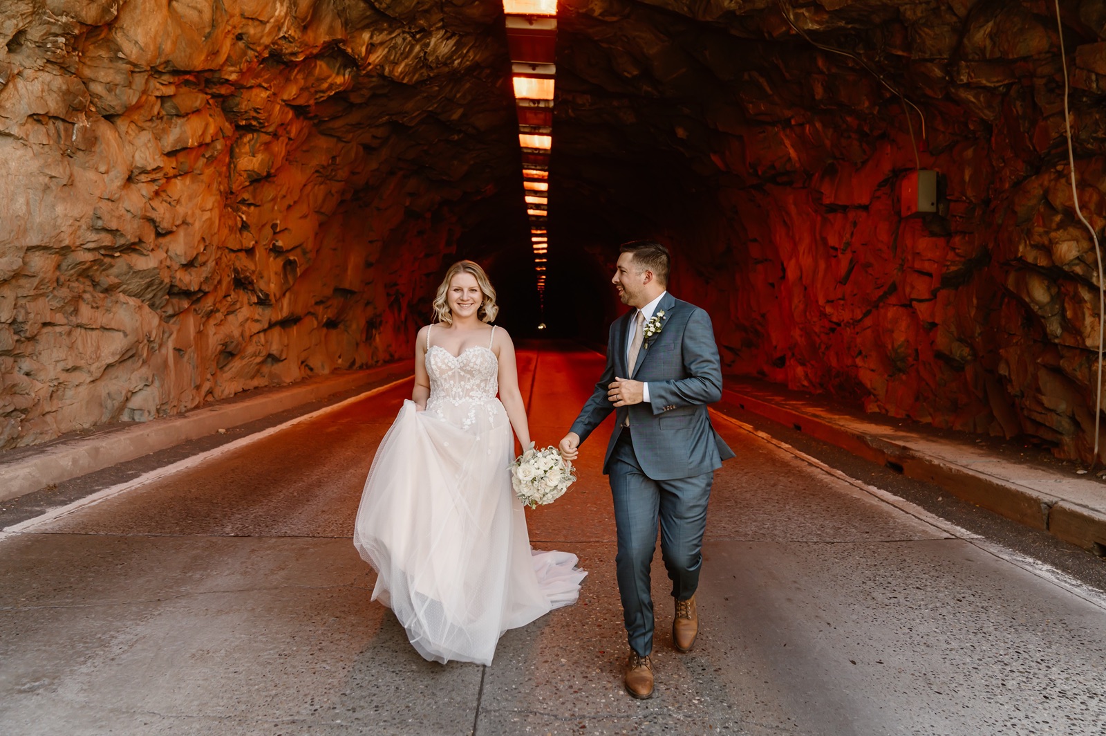 Bride and groom pose in the Yosemite tunnel