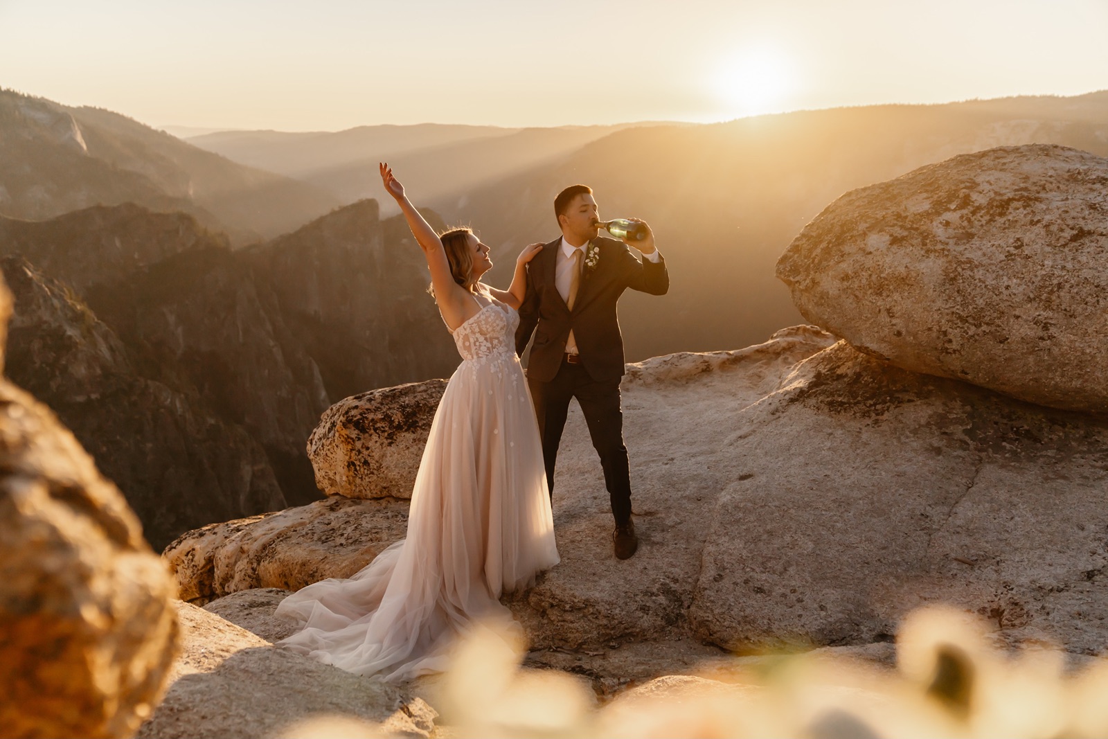 Bride and groom pop champagne during Yosemite elopement hike