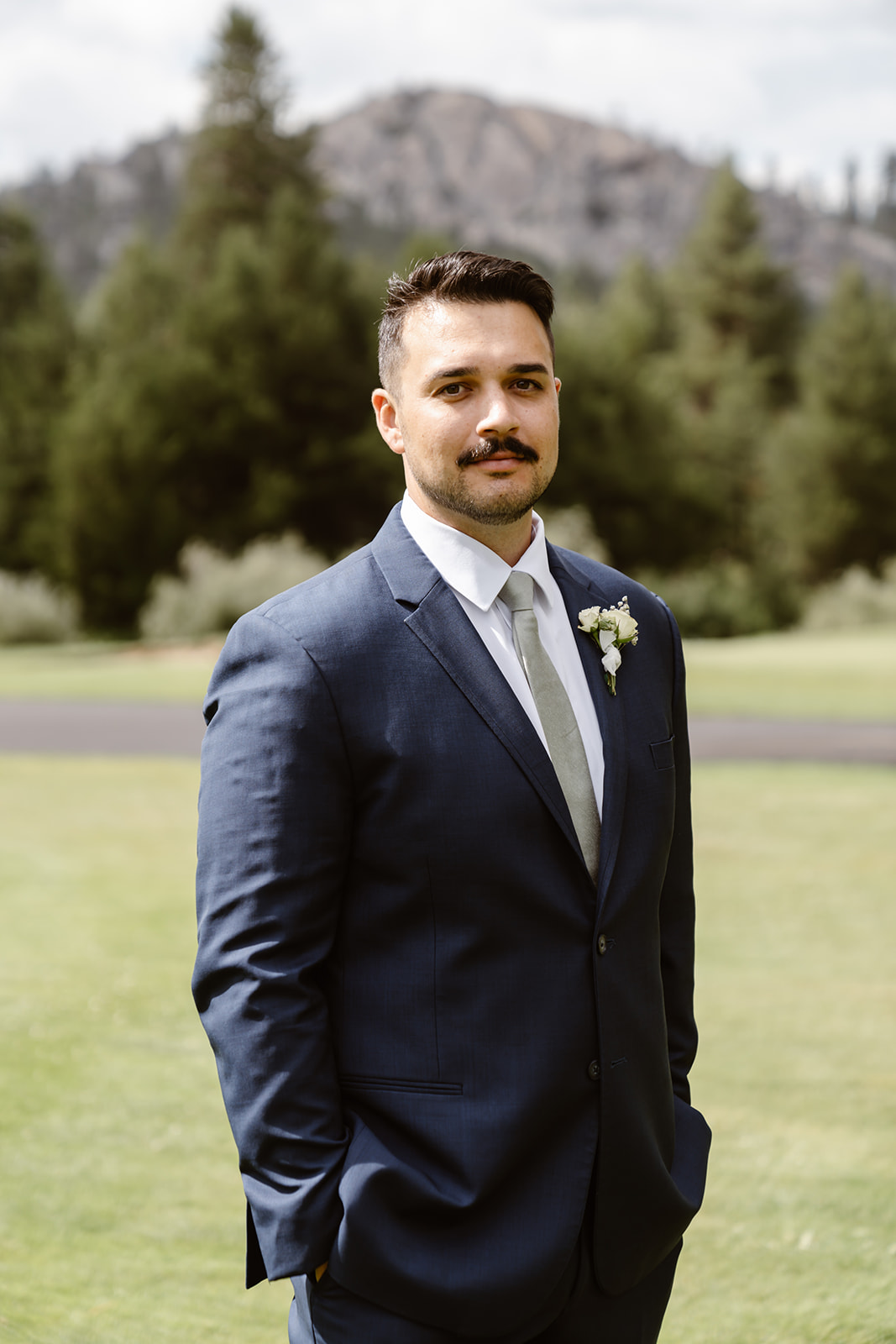 Groom in suit and green tie at Lake Tahoe Golf Course wedding