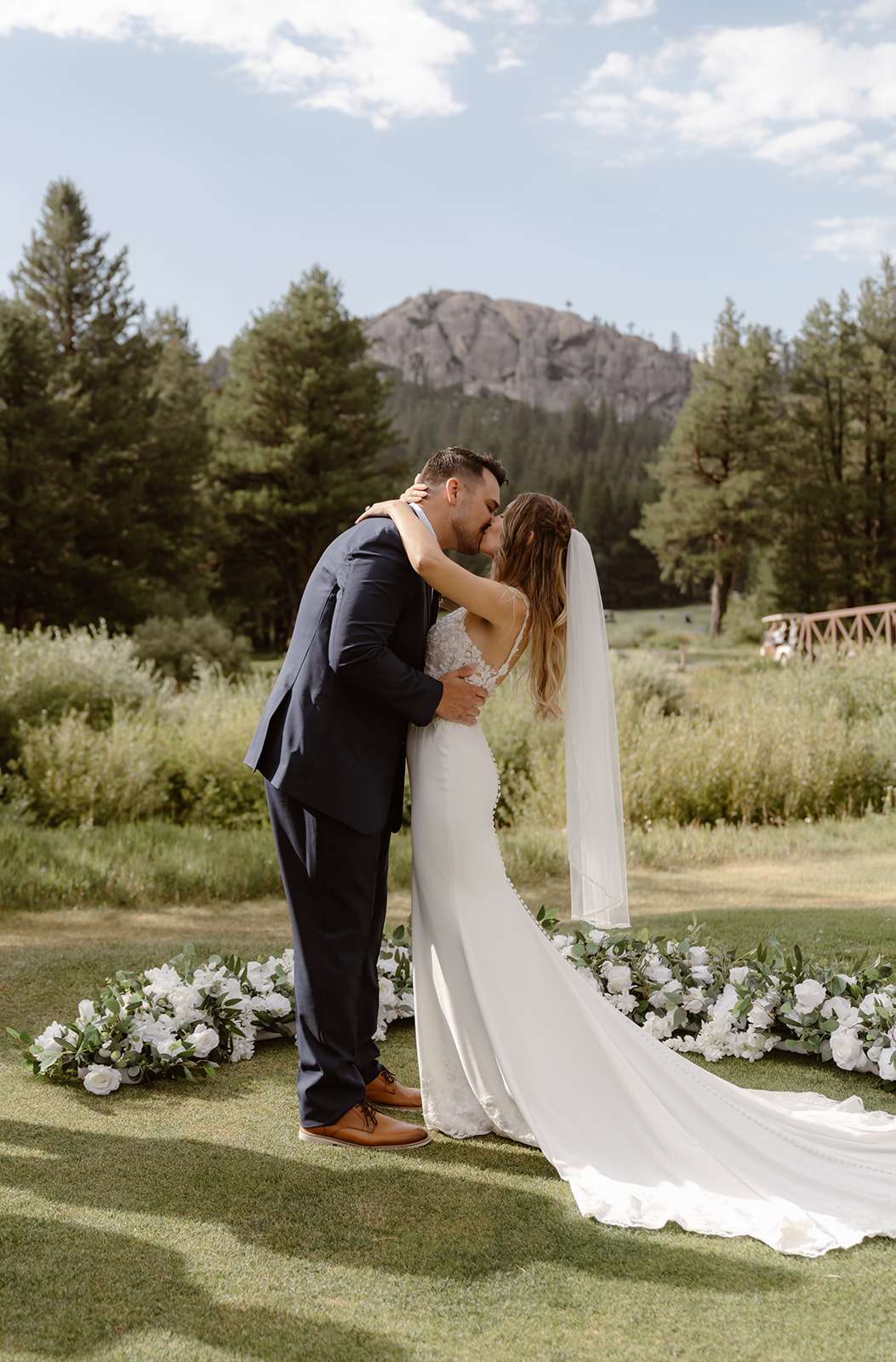 Bride and groom kiss at their Lake Tahoe Golf Course wedding ceremony