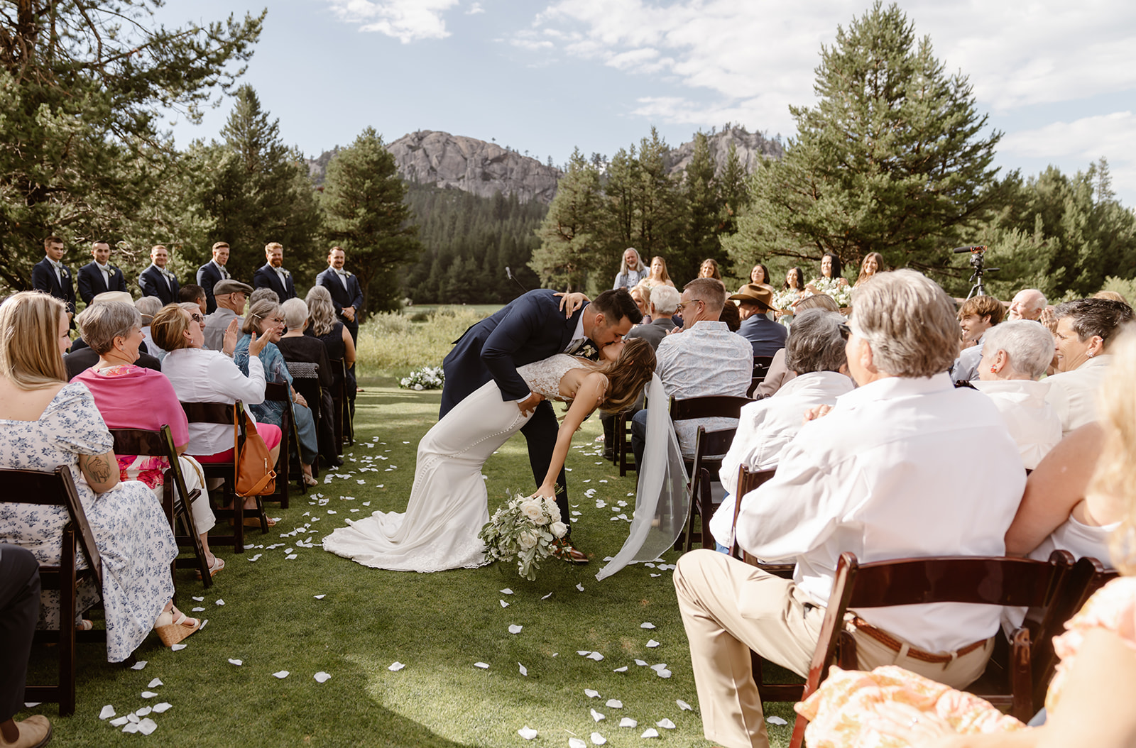 Bride and groom dip and kiss at their Lake Tahoe wedding reception