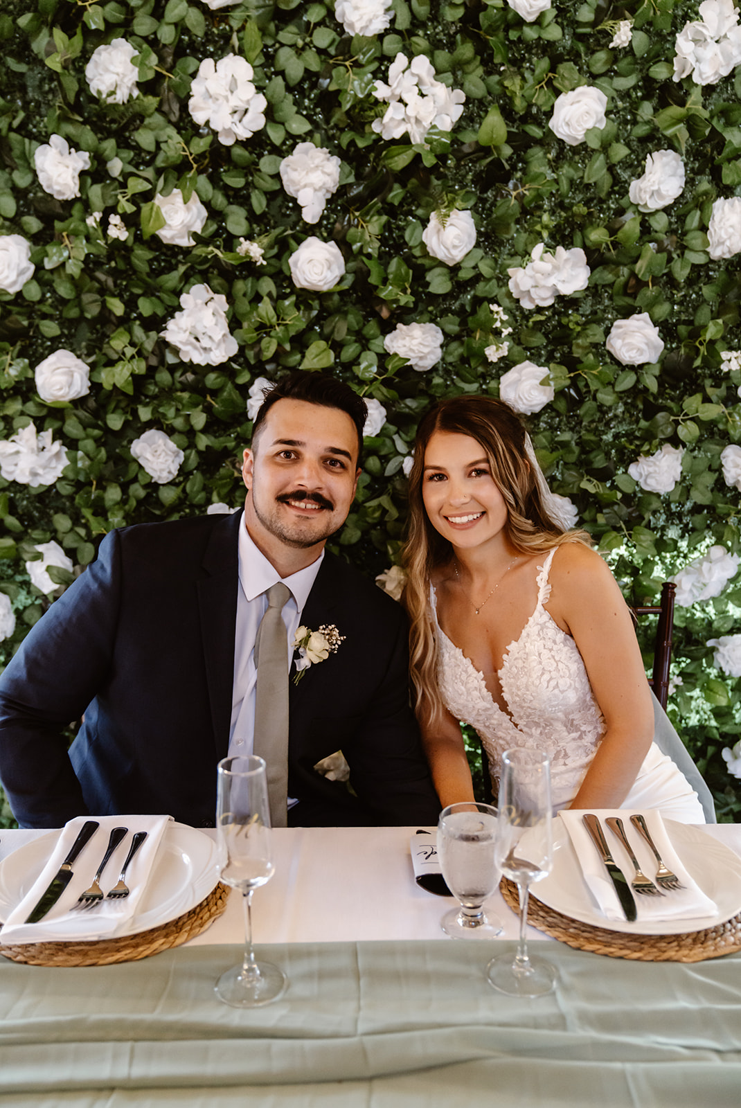 Bride and groom smile at camera during their Lake Tahoe Golf Course wedding reception