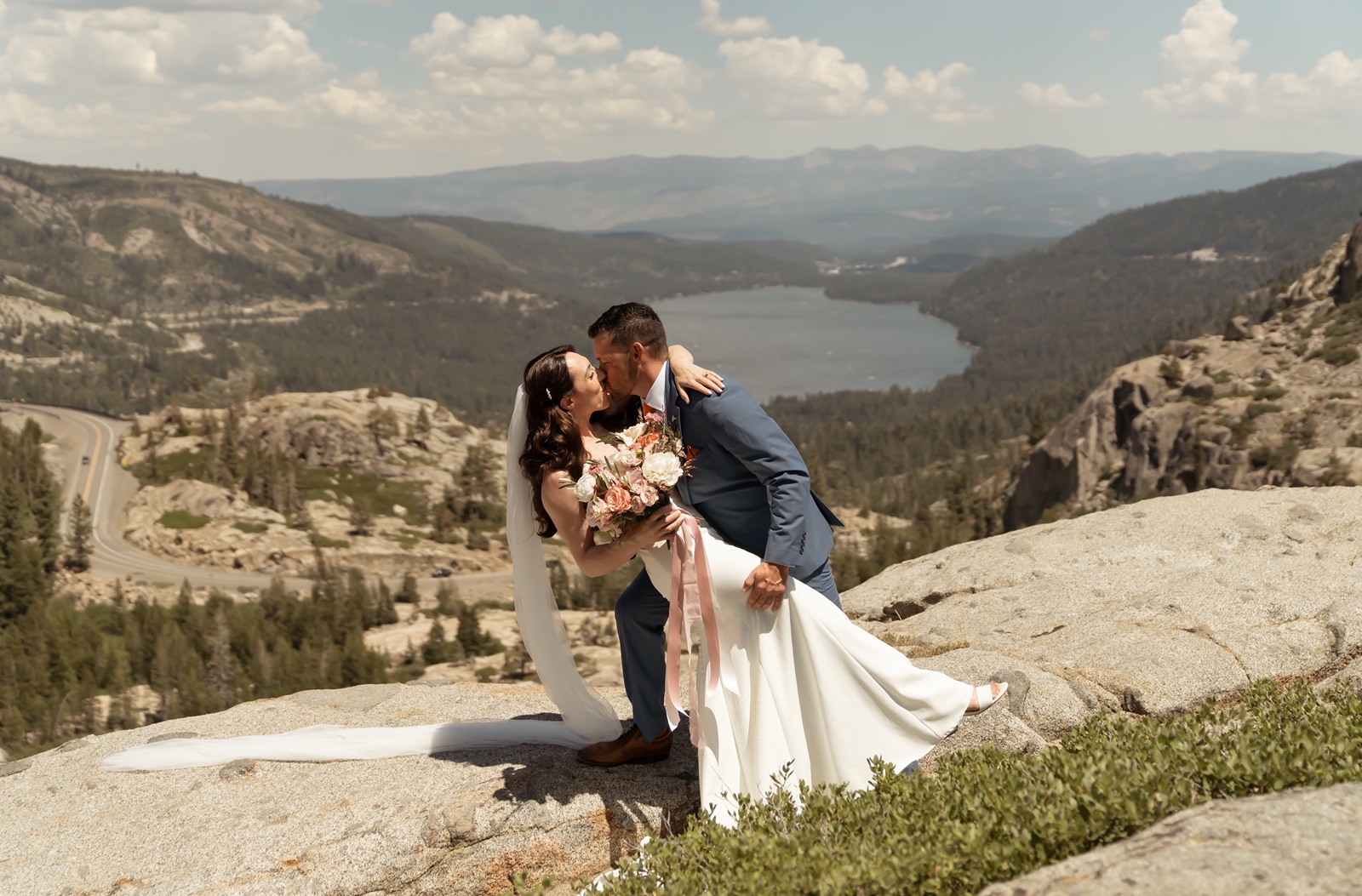 Bride and groom kiss at Donner Lookout during couples portraits