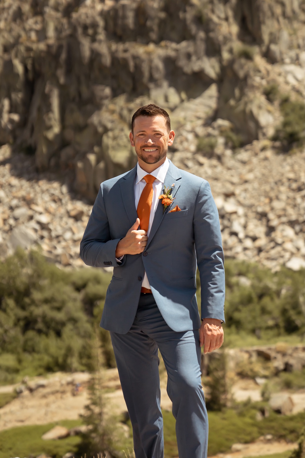 Groom smiles at camera at Donner Lookout