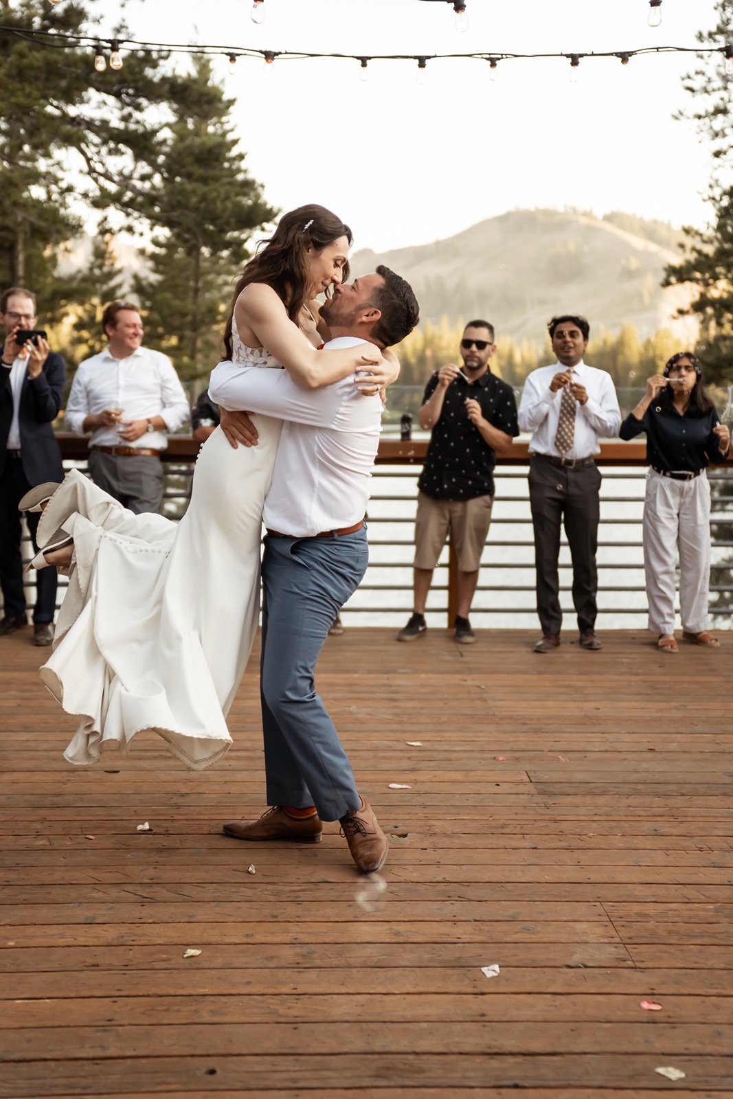 Groom lifts bride during wedding first dance