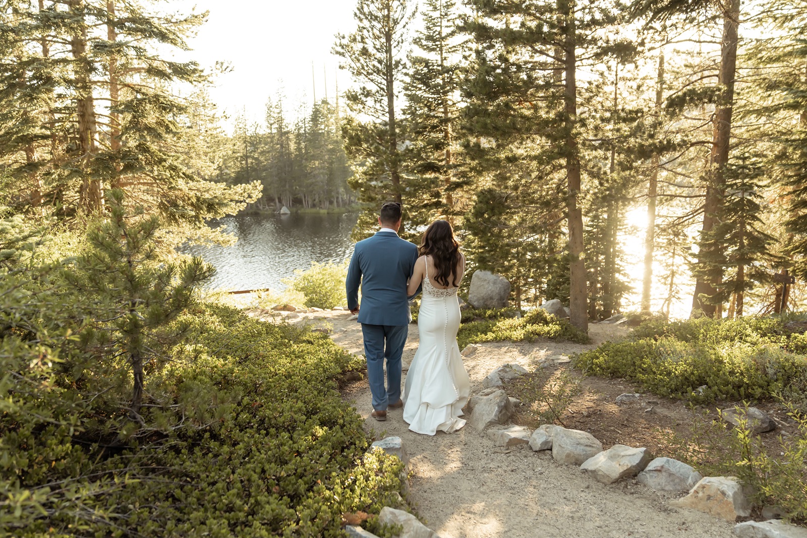 Bride and groom explore their Truckee wedding venue at sunset