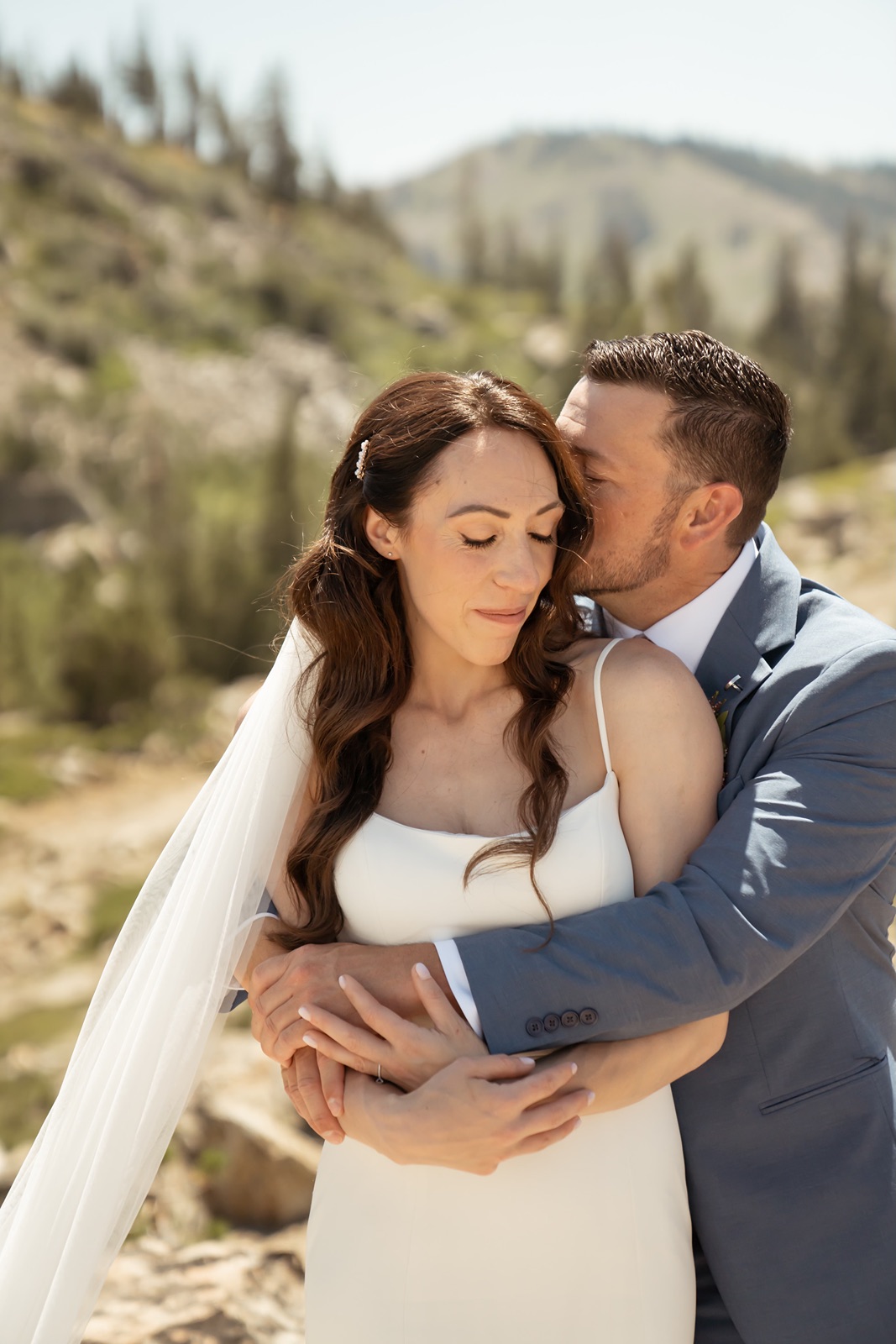 Groom kisses bride on cheek