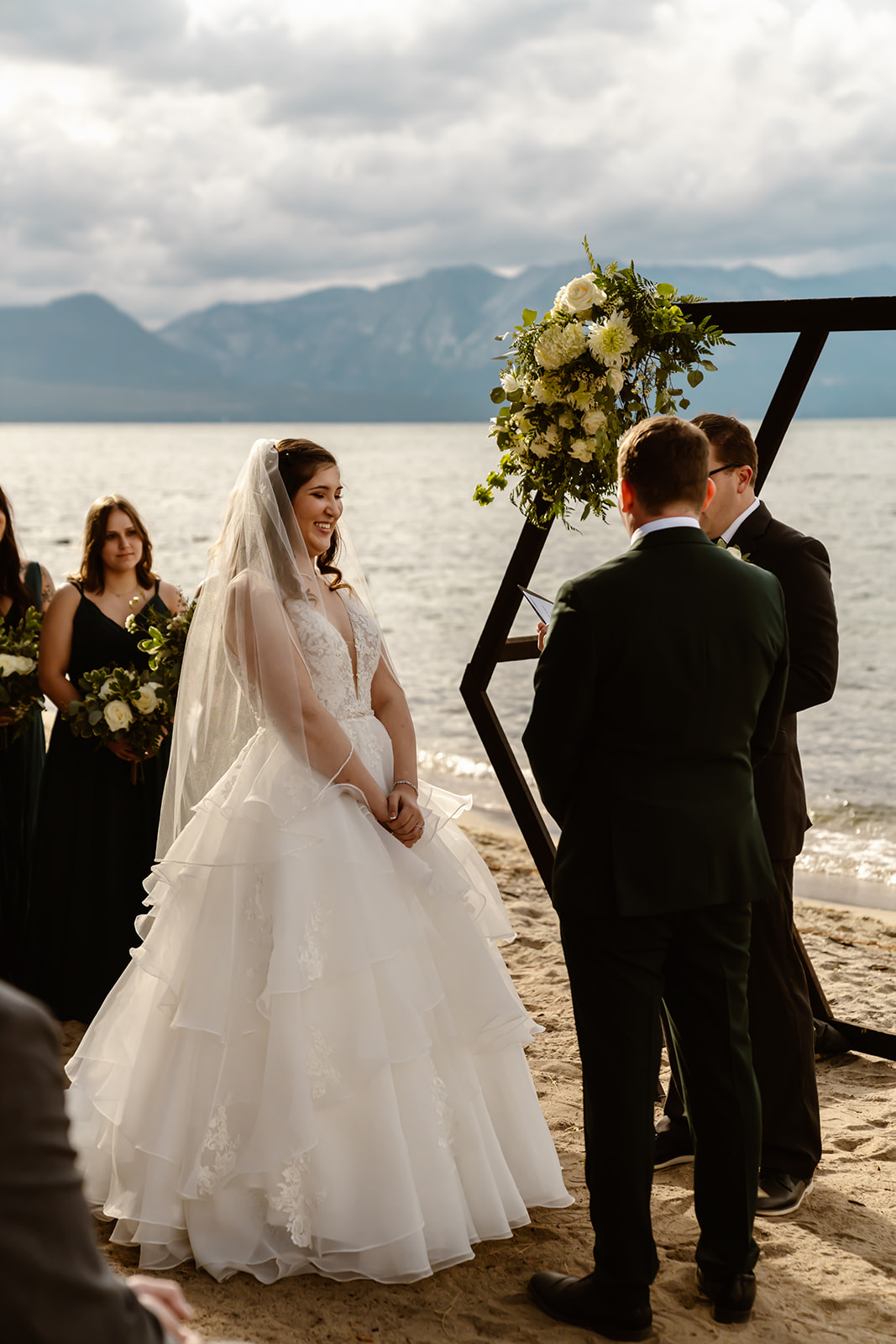 Bride and groom say their vows on the beach at Lake Tahoe