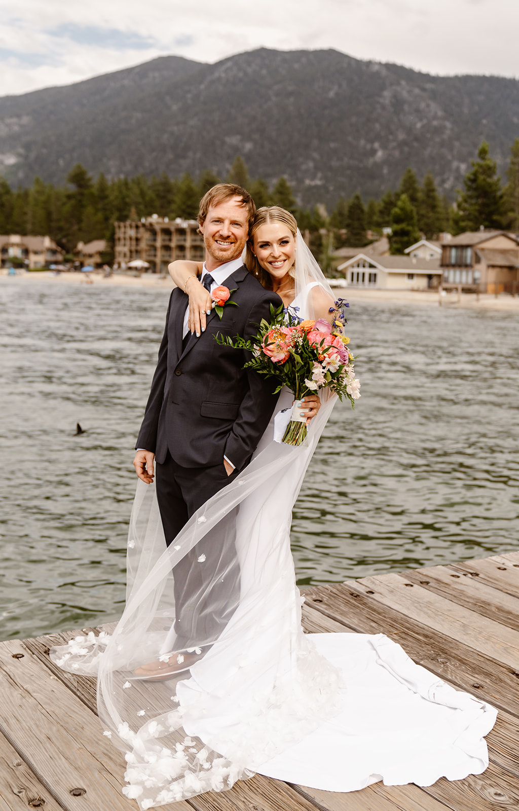 bride with colorful bouquet with groom at Lake Tahoe wedding