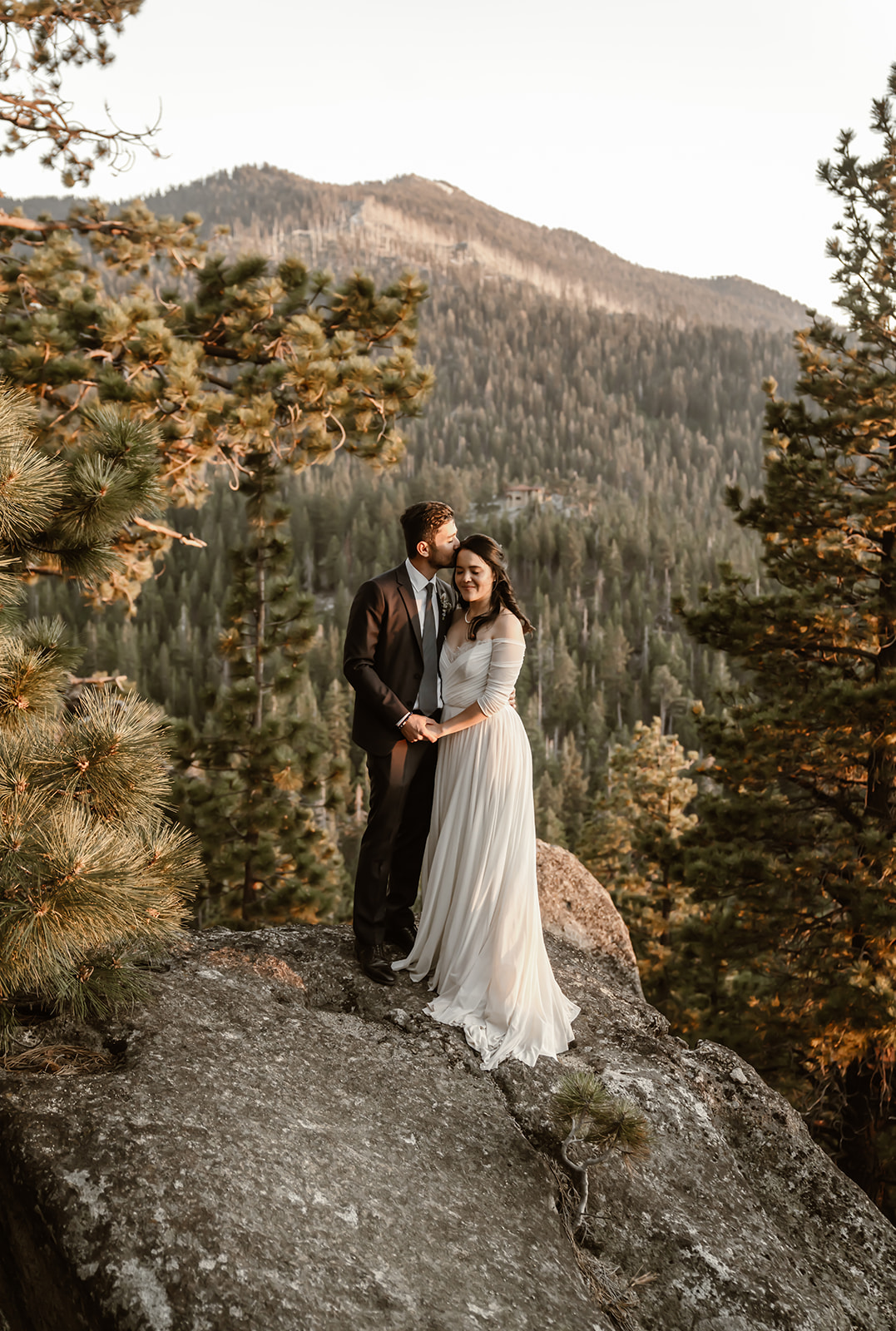 Bride and groom pose for wedding pictures at Lake Tahoe