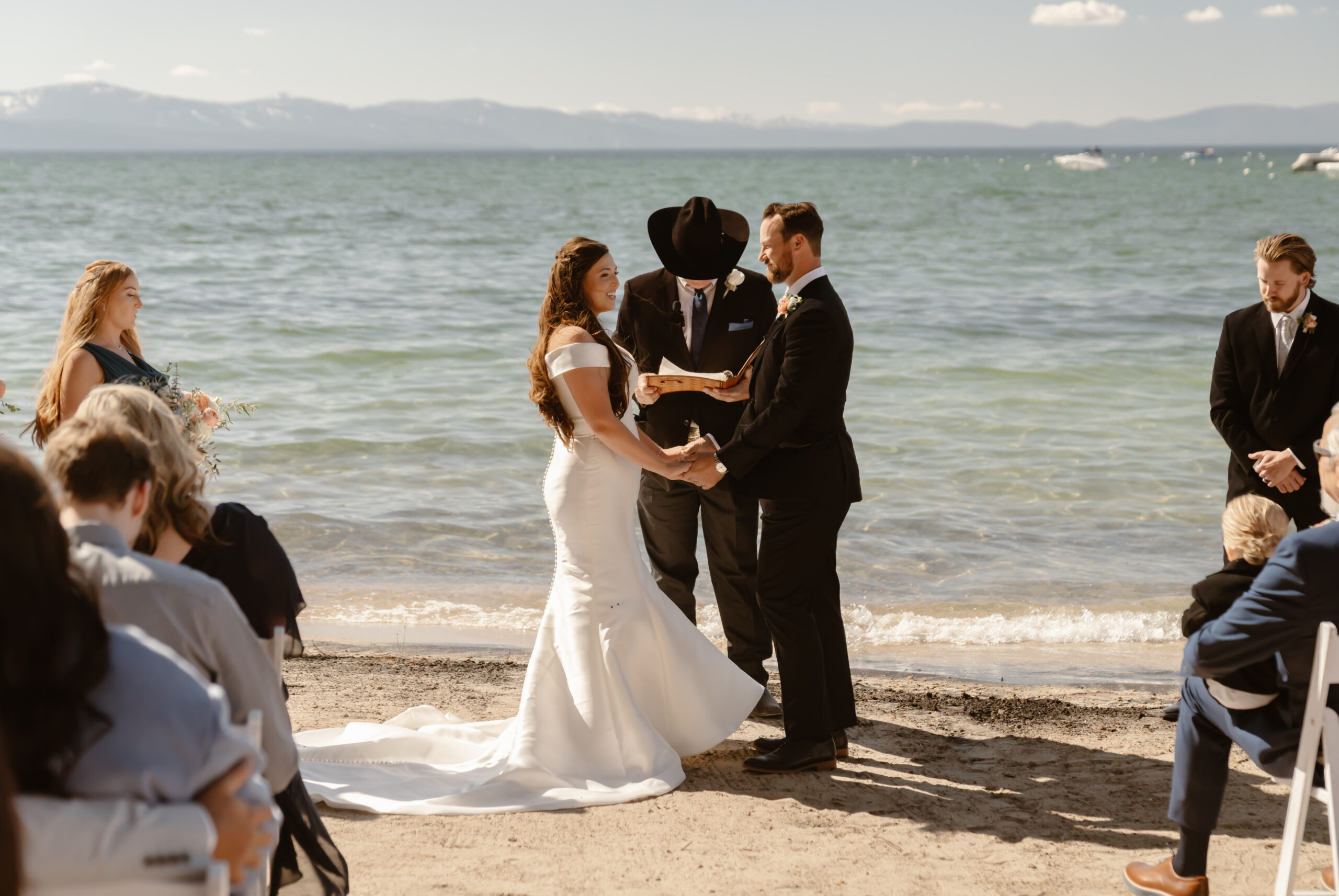 Bride and groom say their vows on the beach at Lake Tahoe