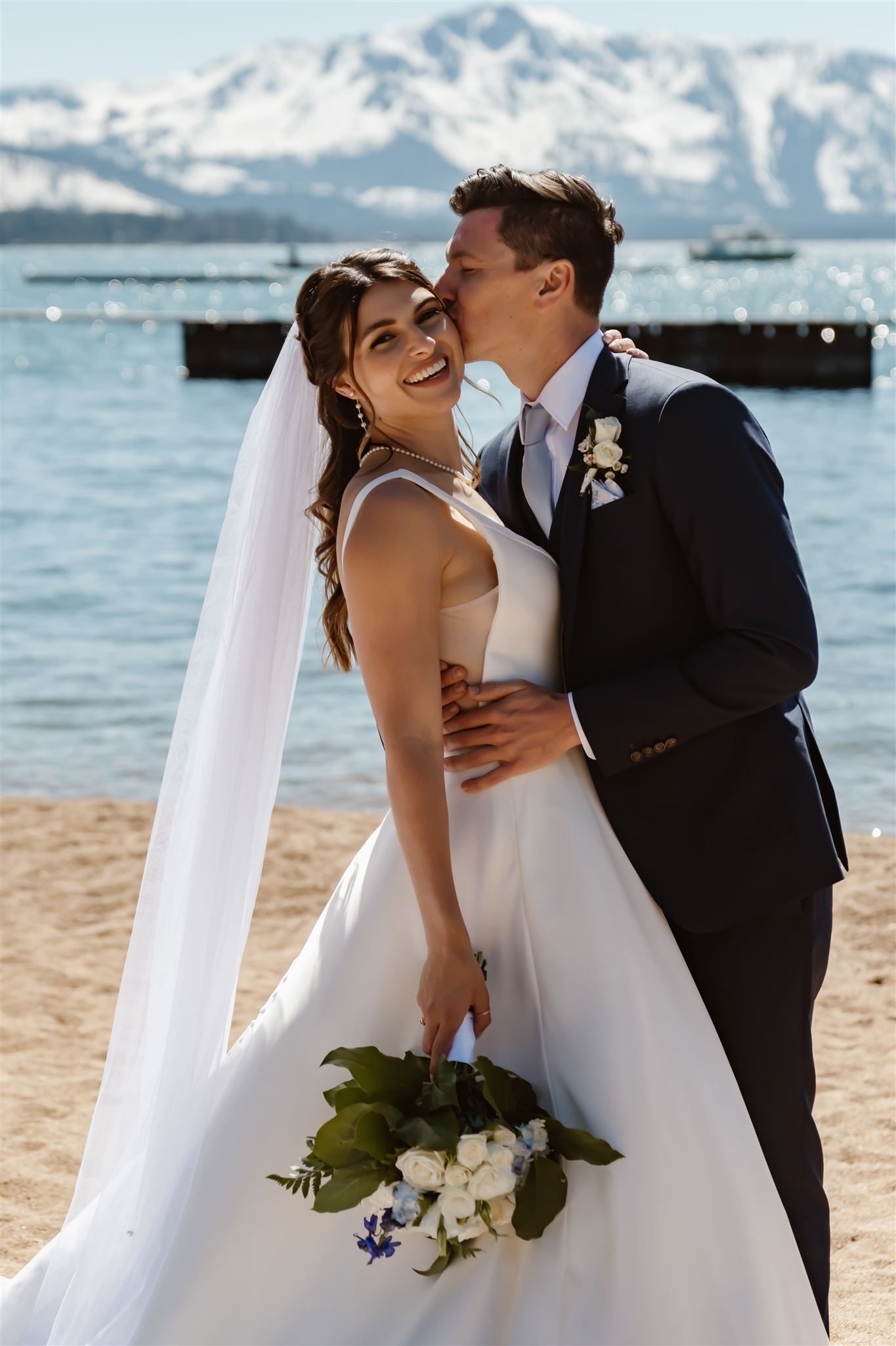 Groom kisses bride on the cheek