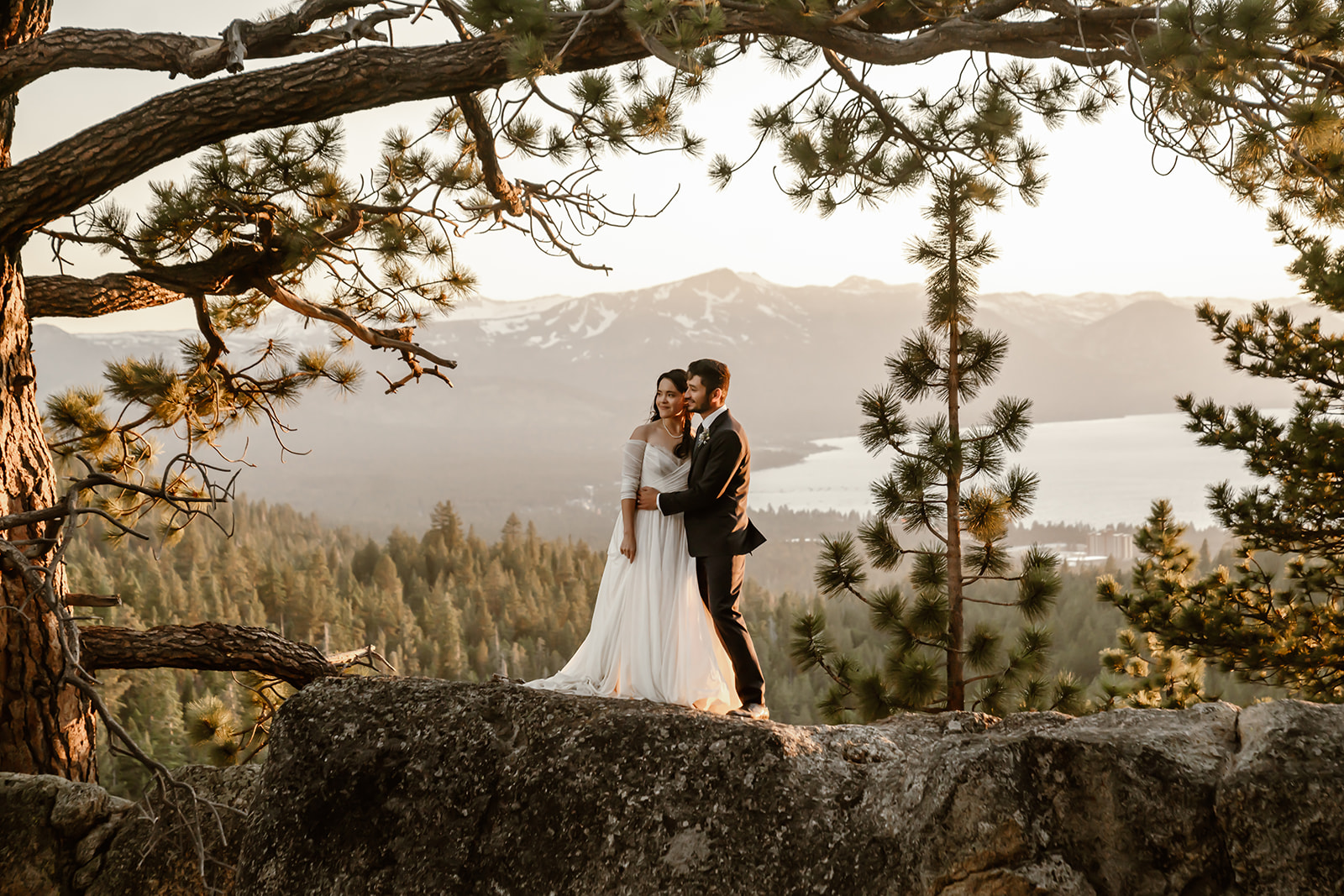 Bride and groom pose with Lake Tahoe wedding backdrop