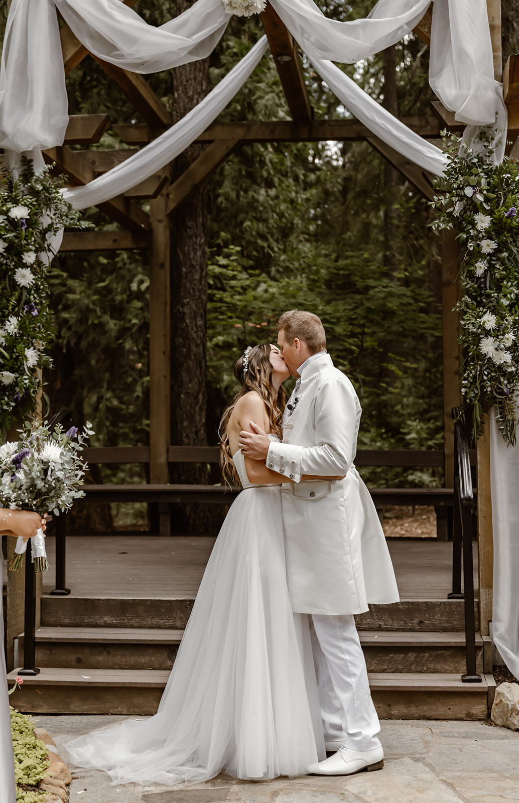 Bride and groom kiss at Harmony Ridge Lodge wedding ceremony