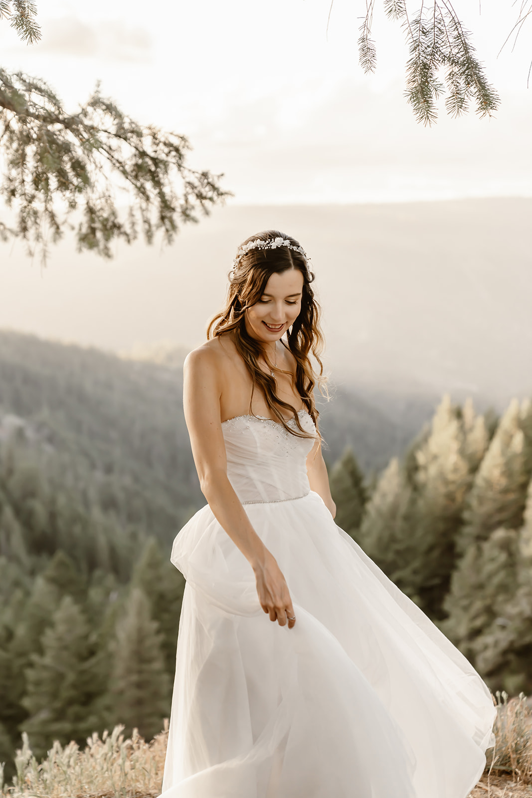 Bride twirls in wedding dress at sunset