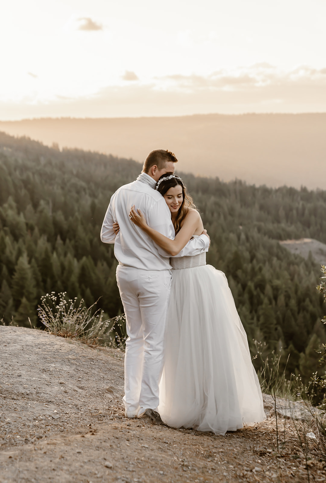 Bride and groom hug near Harmony Ridge Lodge