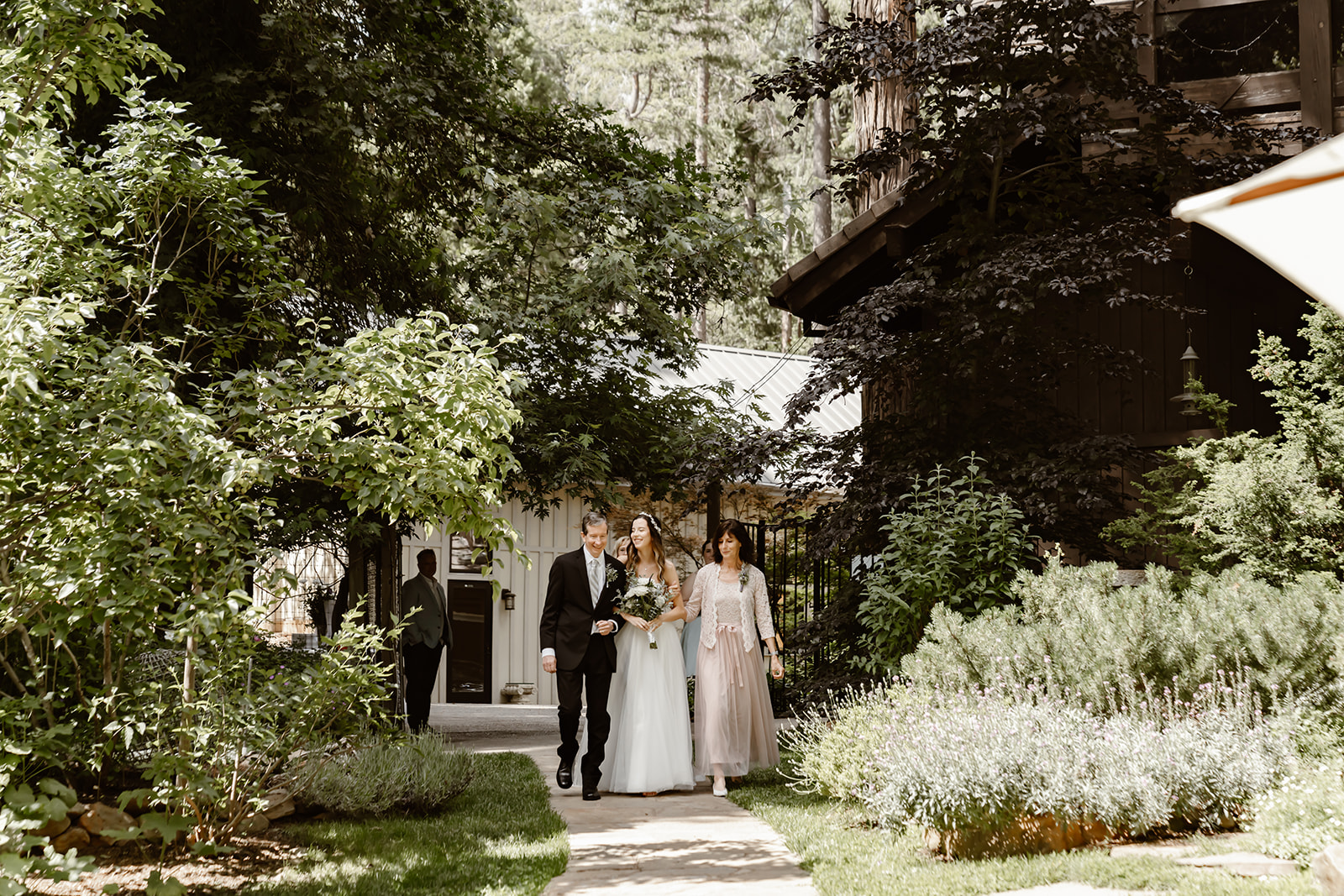 Bride is escorted by her mother and father