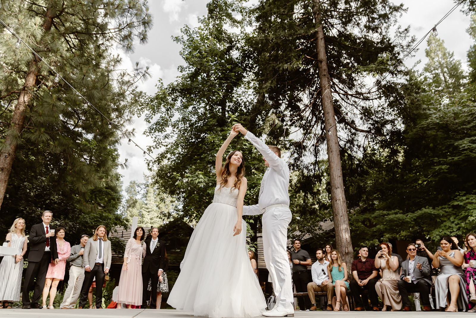 Bride and groom have first dance outdoors at Harmony Ridge Lodge