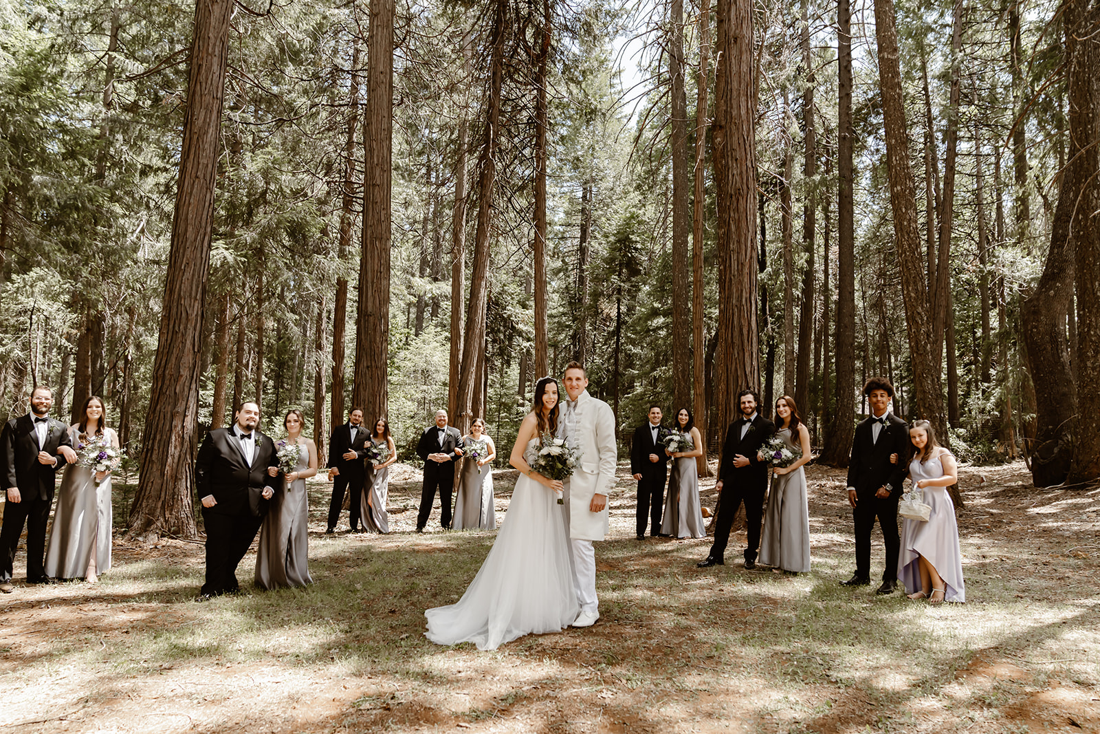 Bride and groom pose with wedding party at Harmony Ridge Lodge