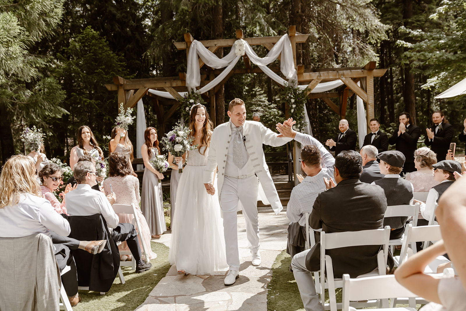 Bride and groom smile as they exit their Harmony Ridge Lodge wedding ceremony