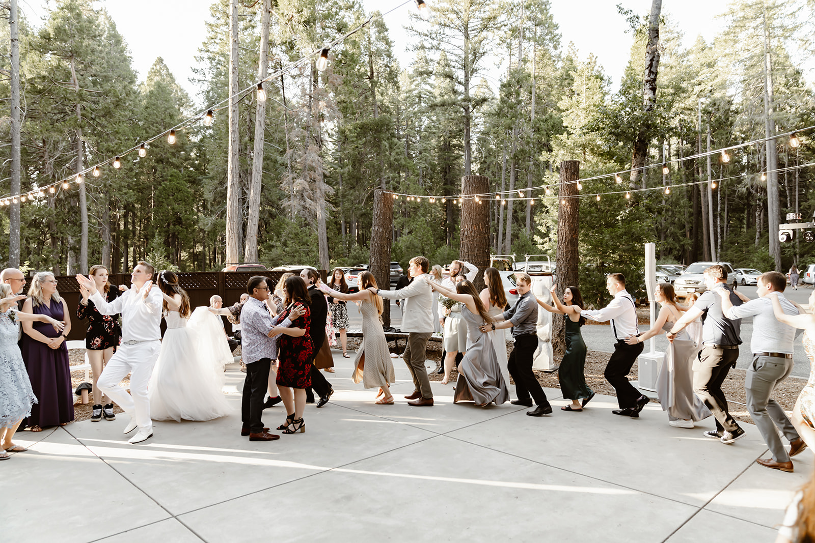 Guests dance under the string lights at Harmony Ridge Lodge