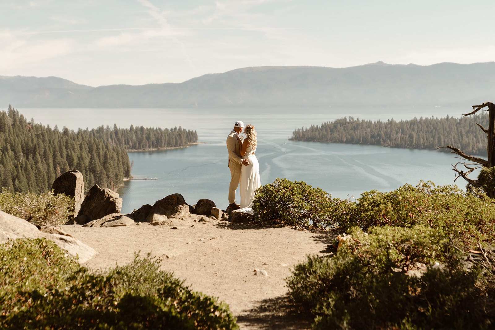 Bride and groom looking out at Emerald Bay