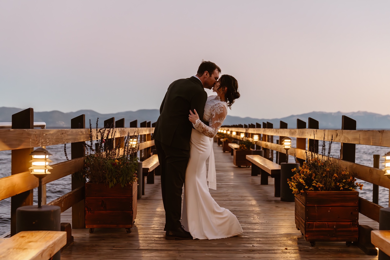 Bride and groom kiss on the pier at their Gar Woods wedding