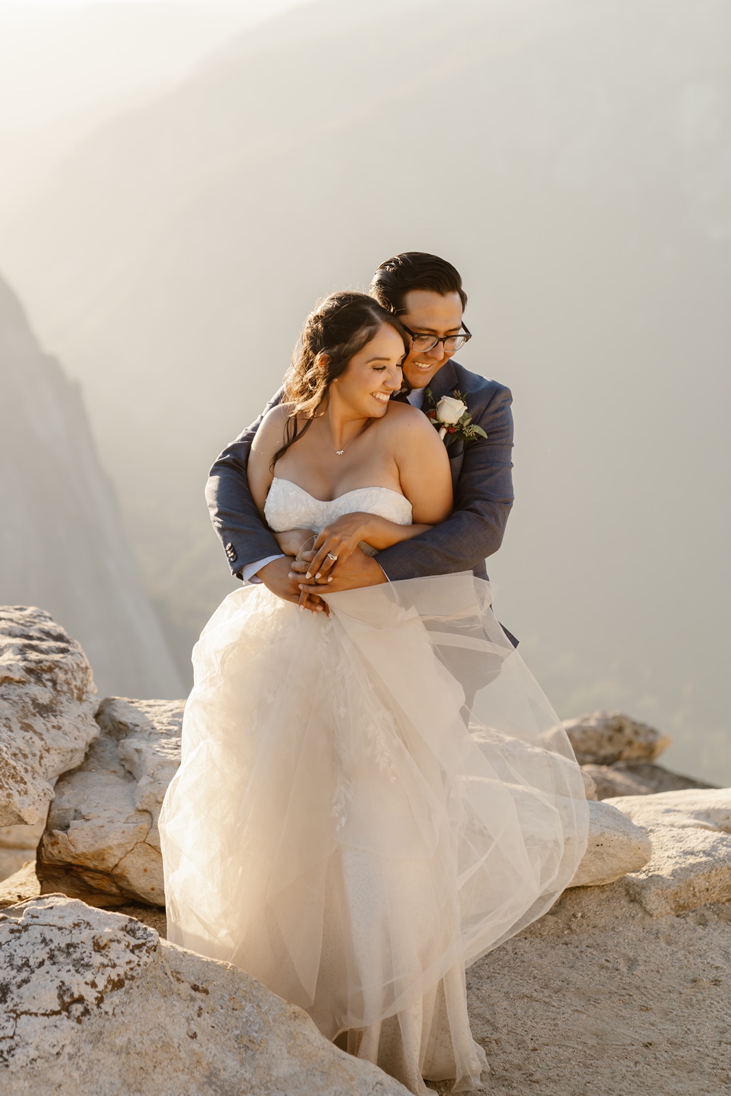 Groom hugs bride from behind at their Taft Point elopement
