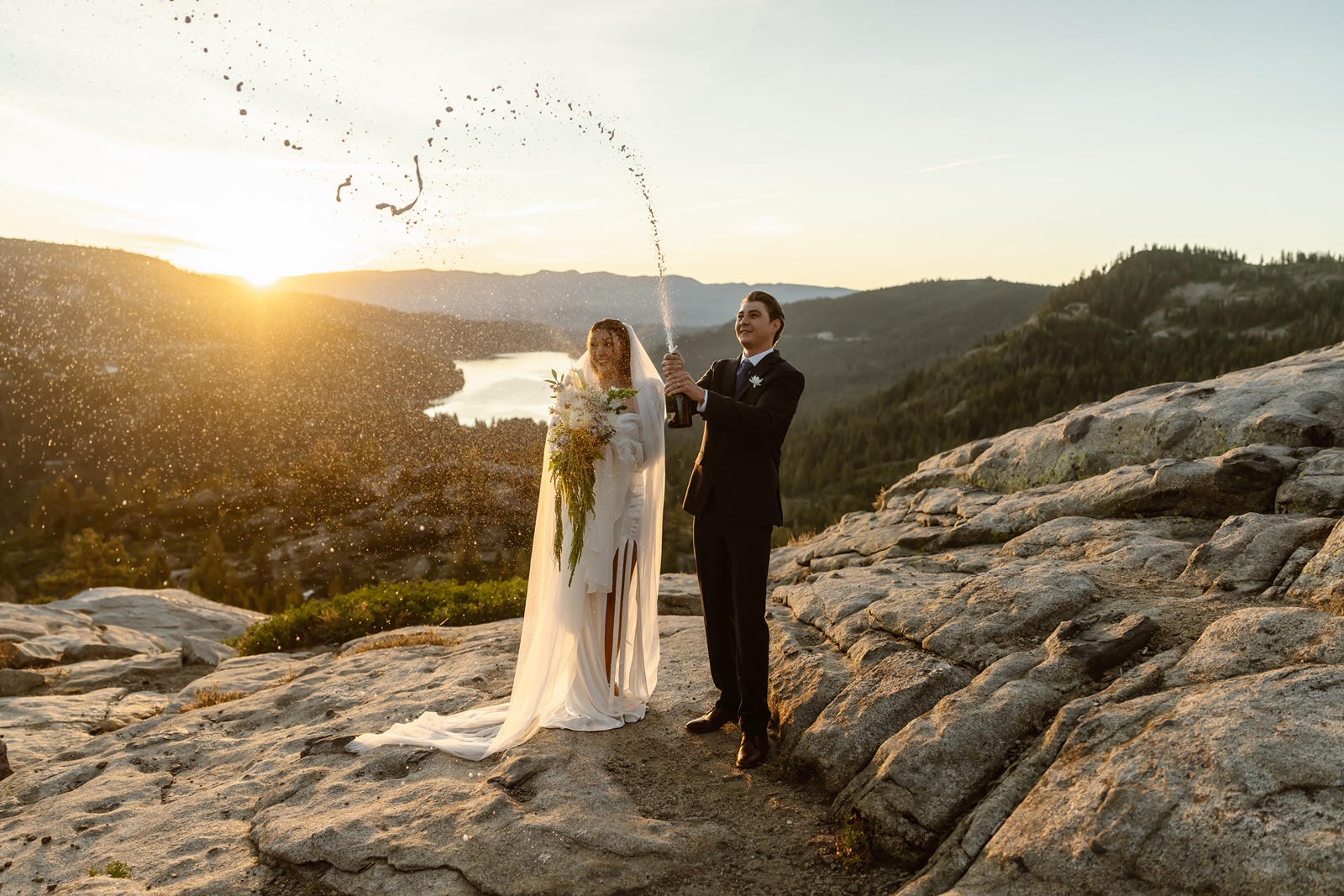 Bride and groom pop champagne at Donner Lake Overlook elopement