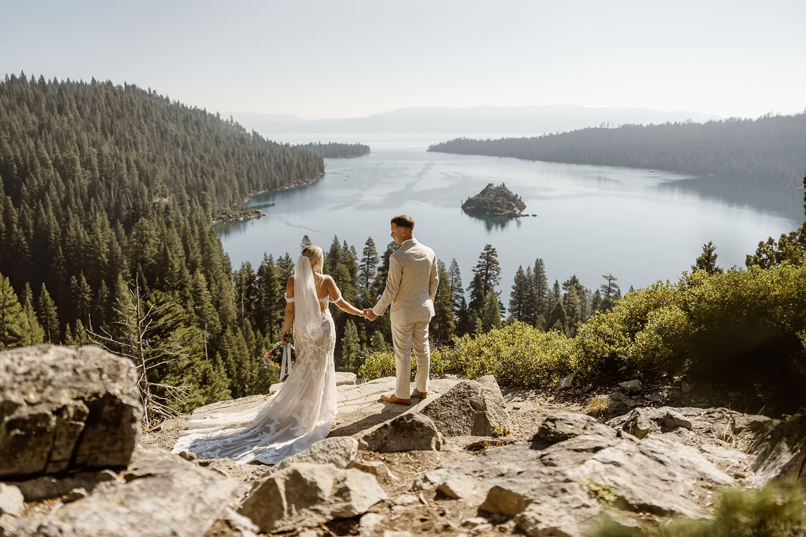 Bride and groom overlooking Emerald Bay and Fannette Island during a Lake Tahoe elopement