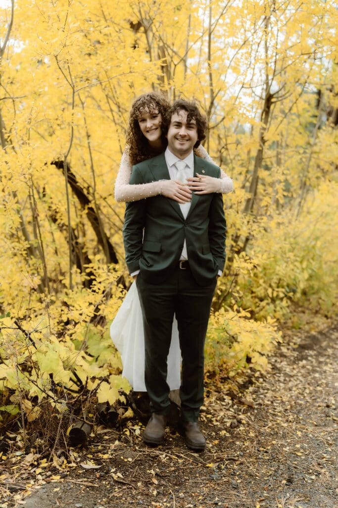 Newlyweds surrounded by golden aspens during a fall Lake Tahoe elopement