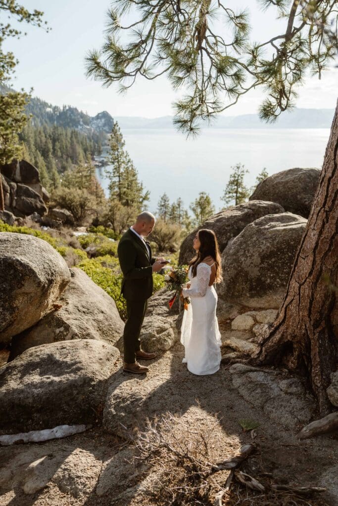 Couple exchanging private vows among granite boulders and pine trees overlooking Lake Tahoe at Logan Shoals.