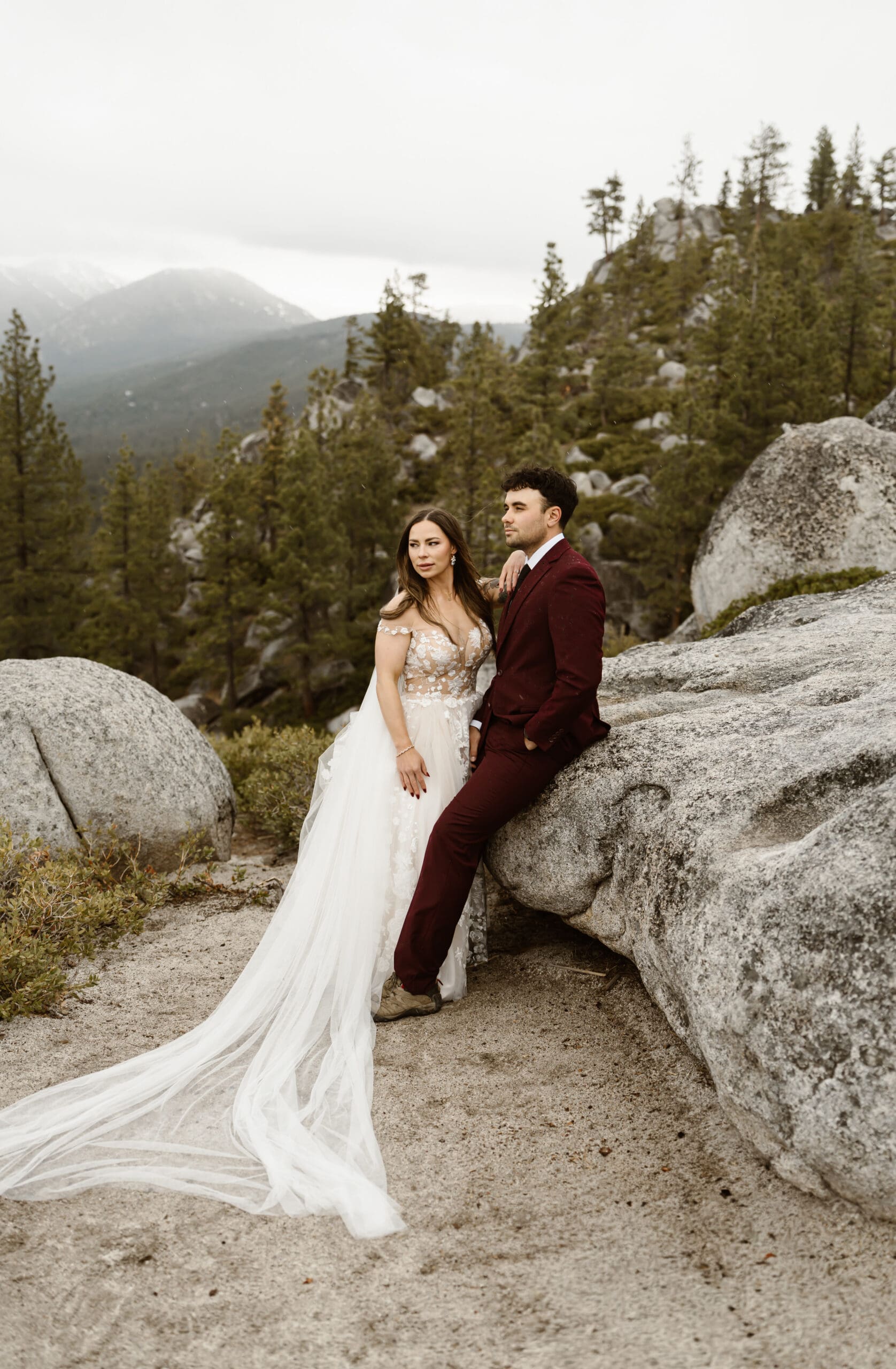 Bride and groom posing among granite boulders and pine trees near Monkey Rock during their Lake Tahoe elopement.