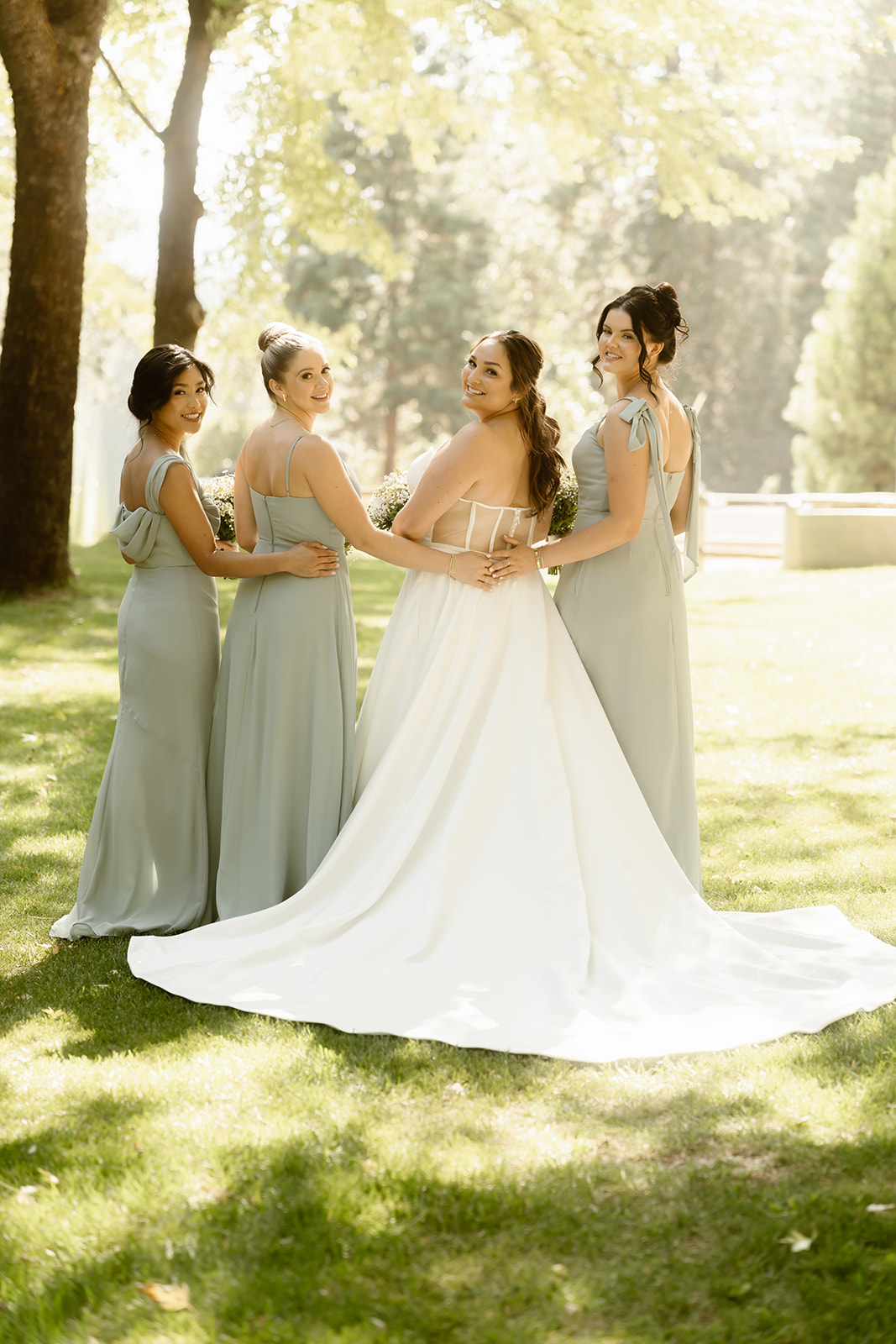 Bride with her bridesmaids in green dresses at the Greenhorn Ranch wedding